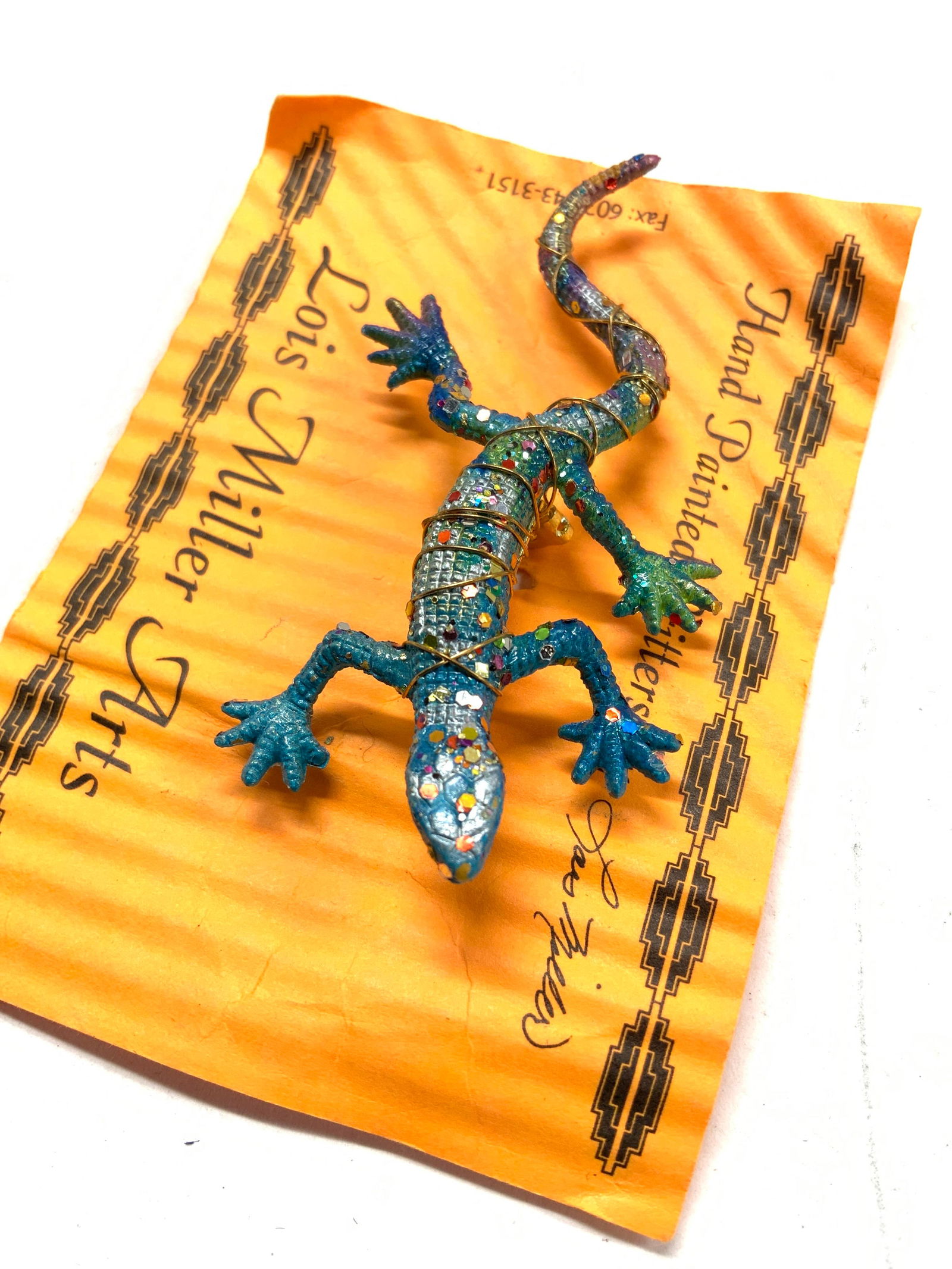 Lois Miller Hand Painted Lizard Brooch, New: hand painted lizard/ chameleon brooch in vivid aqua/ cobalt/ green coloring. Brooch is on original packaging, Lois Miller Arts. Hand wrapped wire around brooch pin. 2.5 x 1.5 in. This appears to be a