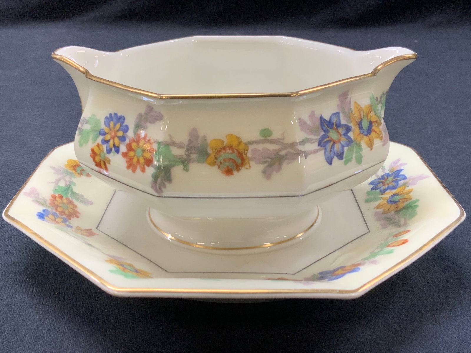 HAVILAND Limoges Porcelain Gravy Boat, France: Marked on underside HAVILAND Limoges France. Off white with floral motifs on plate edges and bowl with girl rims. Approx 3.25 inches tall and 4 inch diameter cup and 7 inch diameter plate. Minor weari