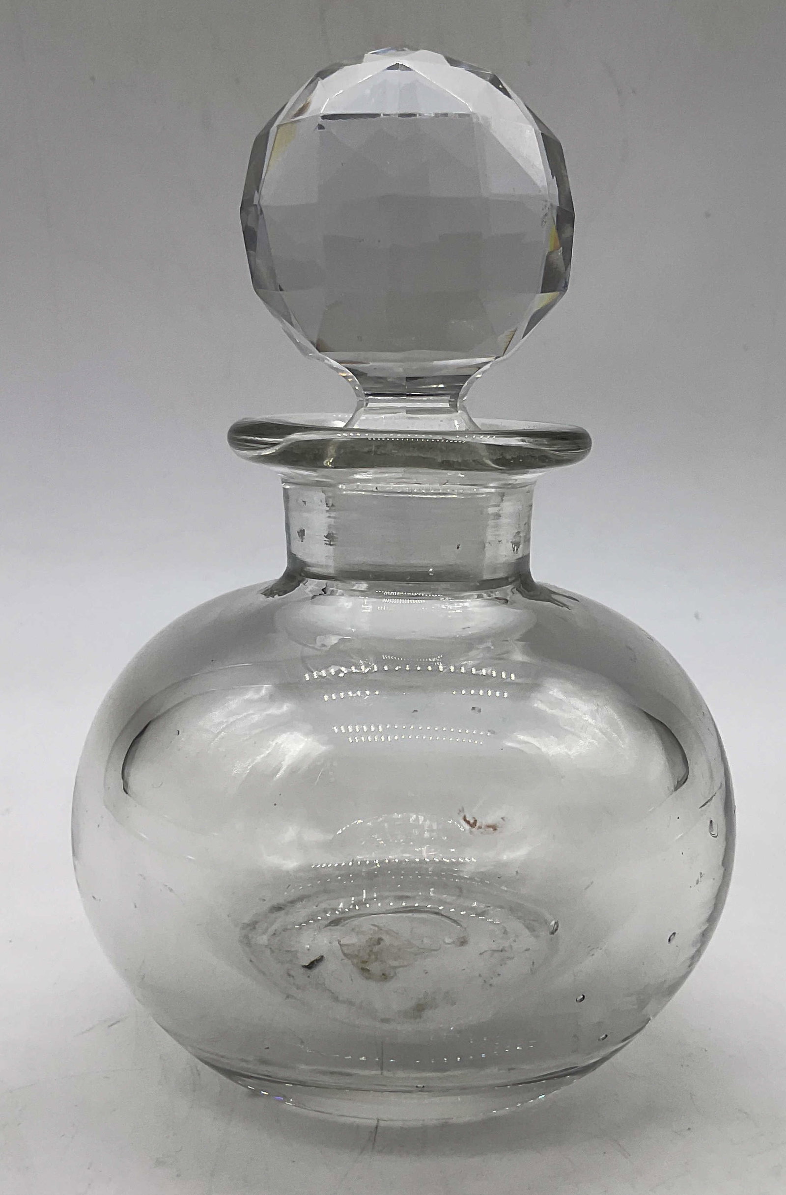 Vtg Heavy Glass Perfume Bottle with Stopper: Vintage Heavy Glass Perfume Bottle with Wheel cut crystal Stopper. Measures approx. 5.5H x 3.25W in. Some residue present. Toiletry accessories, home decor, home accents. 5S