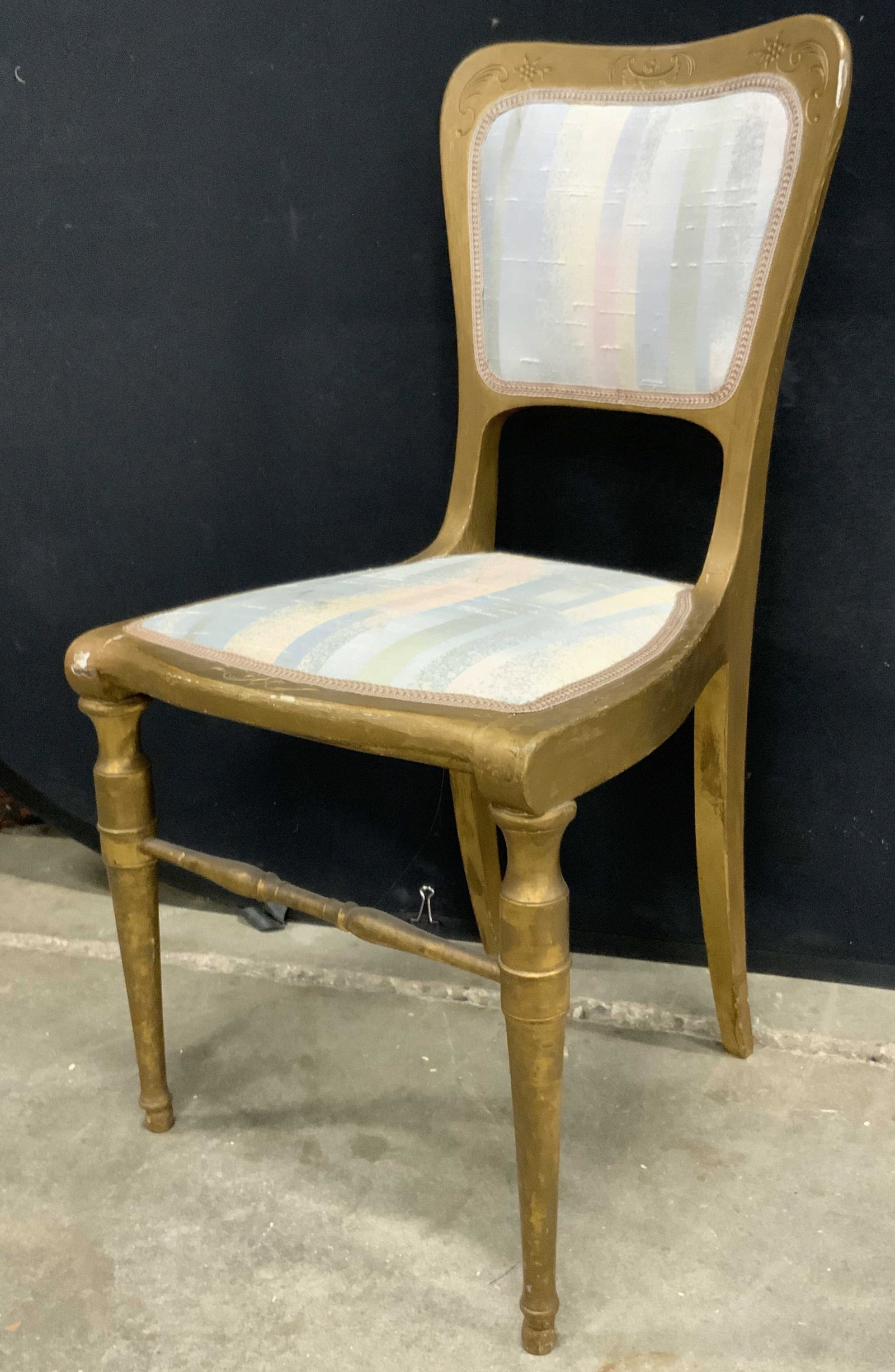 Antique Gilt Wood Upholstered Side Chair: A vintage, possibly antique, gilt wood side chair featuring striped soft hand upholstery. Upholstery is pink, green, blue, and white hues. Carved floral and foliage motif to the wood. Some surface wea