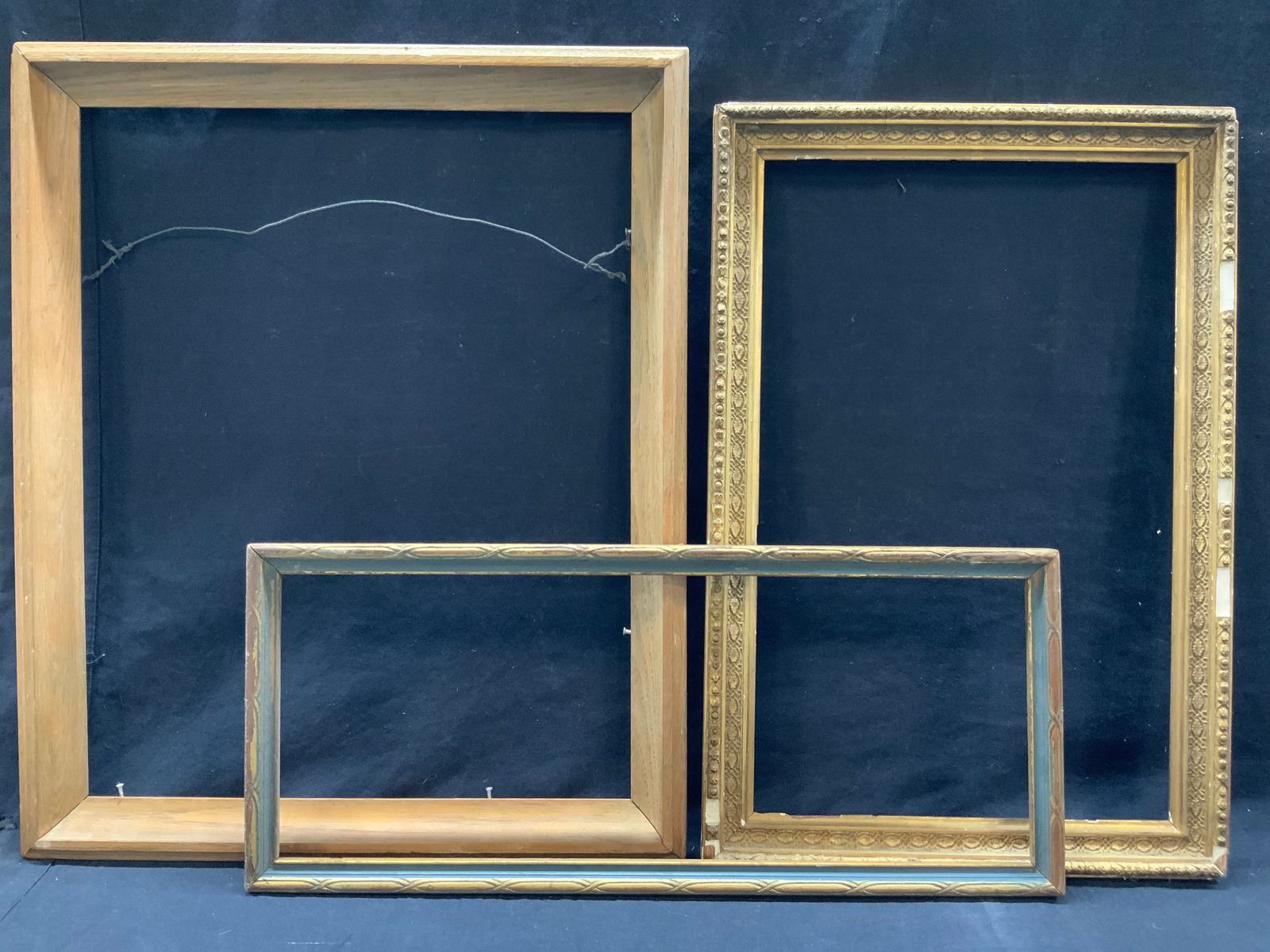 Lot 3 Vintage Wooden & Gilt Wall Frames: Lot of 3 wooden picture frames. 1of tan wood, approx 22.5 x 18.5 inches window measures 19. X 15.5 inches. 1 gilt ornately carved wooden and plaster made frame 21 x 14 inches window measure 18 x 11.5