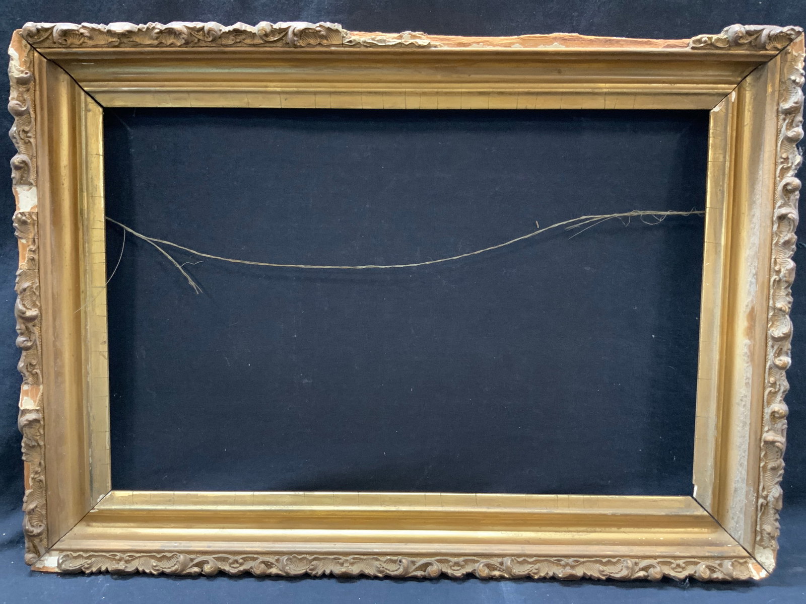 Vintage Gold Leafed Wooden Canvas Frame 2ft: Vintage wooden frame with gold leaf and textured scroll designs on outer edges. Approx 17 x 24 inches window measures 12.75 x 19 inches Evident loss to scroll designs on outer edges and wearing to lea