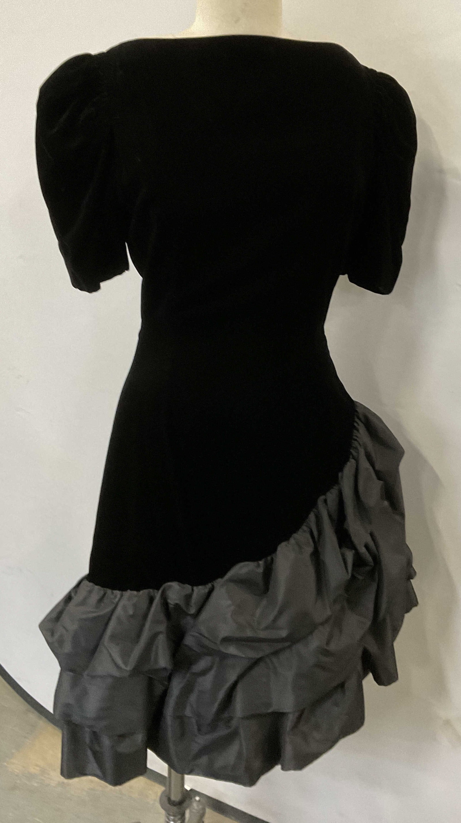 Vintage SCAASI Black Velvet Dress: Vintage SCAASI Black Velvet Dress With short puff sleeves and Ruffled skirt. Zipper at back. Size 10. Label reads: Union Made Int. Ladies Garment Workers Union. Some surface wear consistent with age, 