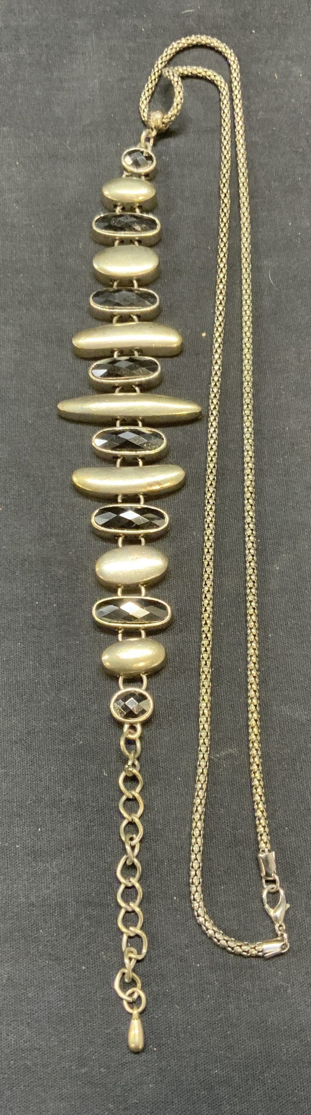 Vintage Silver Tone Crystal Pendant Necklace: Vintage silver tone crystal pendant necklace. Drop length approx. 13.75 inches. Pendant drop length approx. 11.5 inches. Some surface wear including scratching observed. Estate jewelry, costume jewelr
