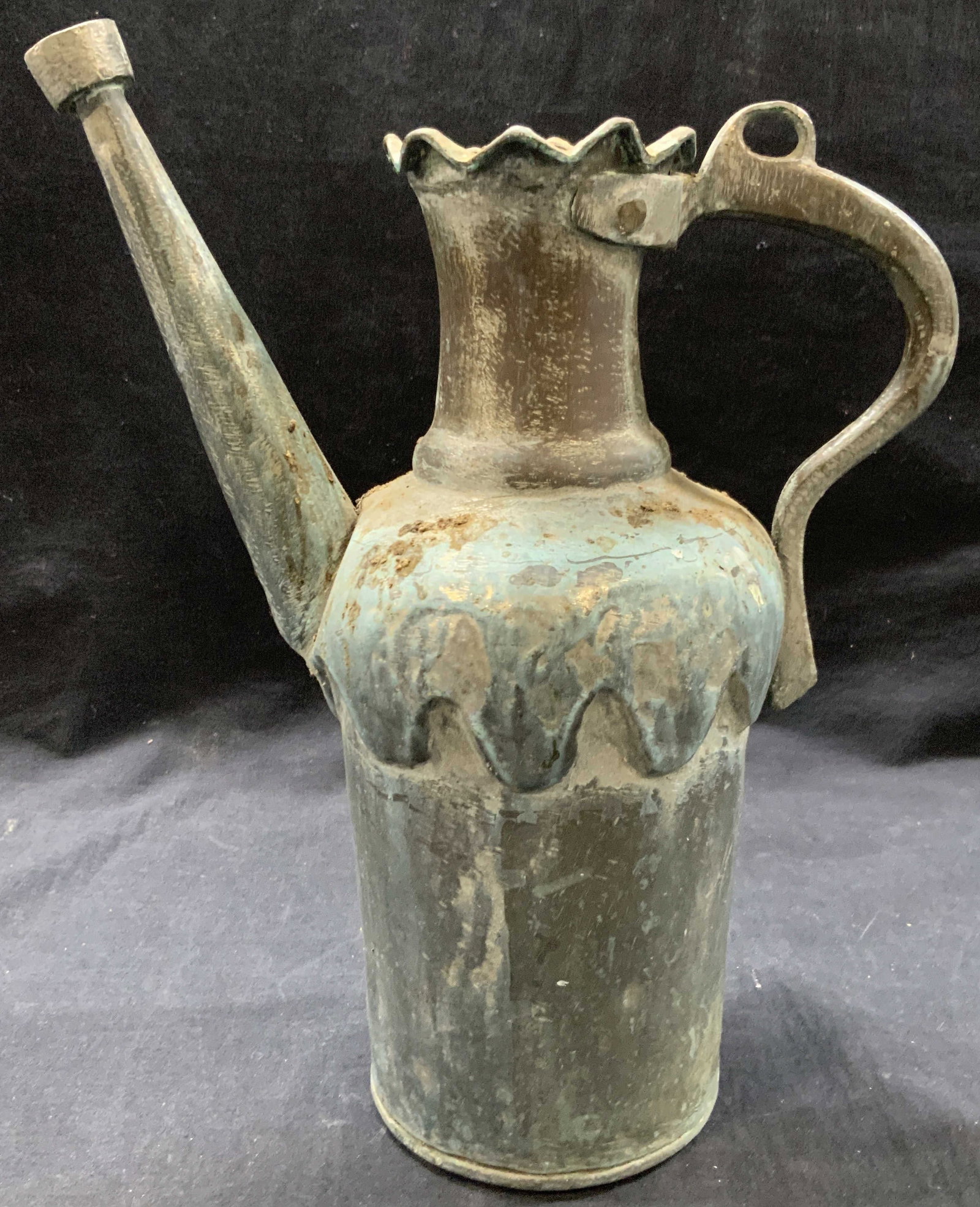 Vintage Aluminum Watering Can: Vintage aluminum watering can with drip style design on exterior and saw tooth edges on top rim with straight up spout and side handle. Approx 13.5 inches tall and 11 inches wide. Evident discoloratio