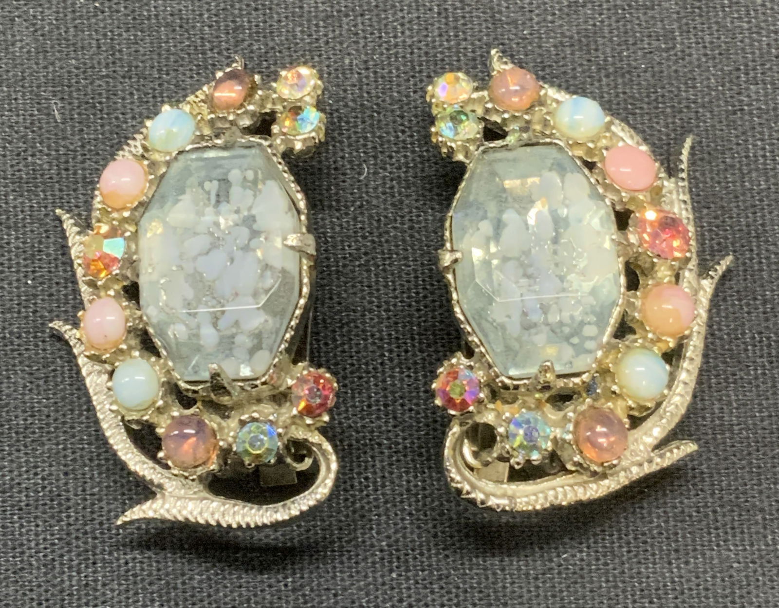 Vintage FLORENZA Silver Tn Crystal Earrings: Vintage FLORENZA silver tone clip on earrings with multi color crystal decoration. Unsigned. Measure approx. 1.5 x 1 inches. Some surface wear including scratching observed. Estate jewelry, costume je