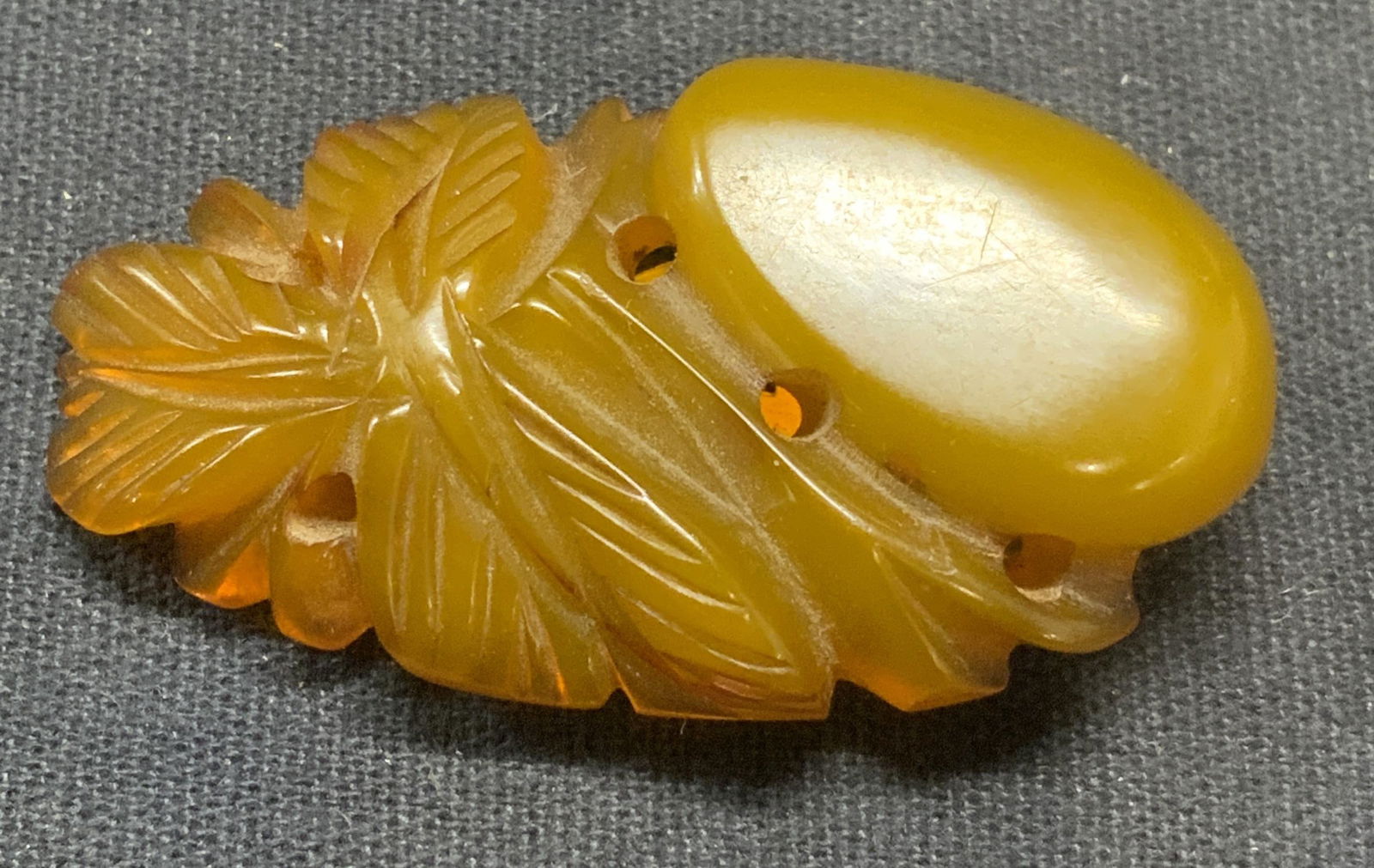 Vintage Amber Tone Lucite Botanical Fur Clip: Vintage amber toned carved lucite fur clip with botanical motif. Measures approx. 1.75 x 1 inches. Some surface wear including scratching observed. Estate jewelry, costume jewelry, fashion jewelry, co