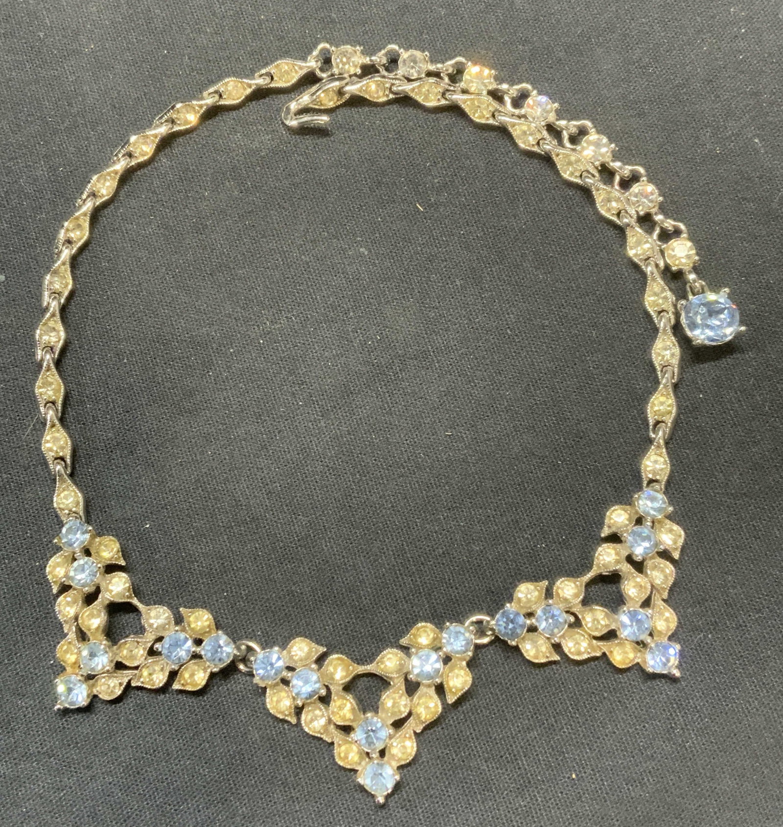 Vintage Bogoff Silver Tn Blue Crystal Necklace: Vintage Bogoff silver tone necklace with blue and colorless crystal decoration. Signed to underside. Drop length approx. 7 inches. Includes jewelry box. Some surface wear including scratching and disc