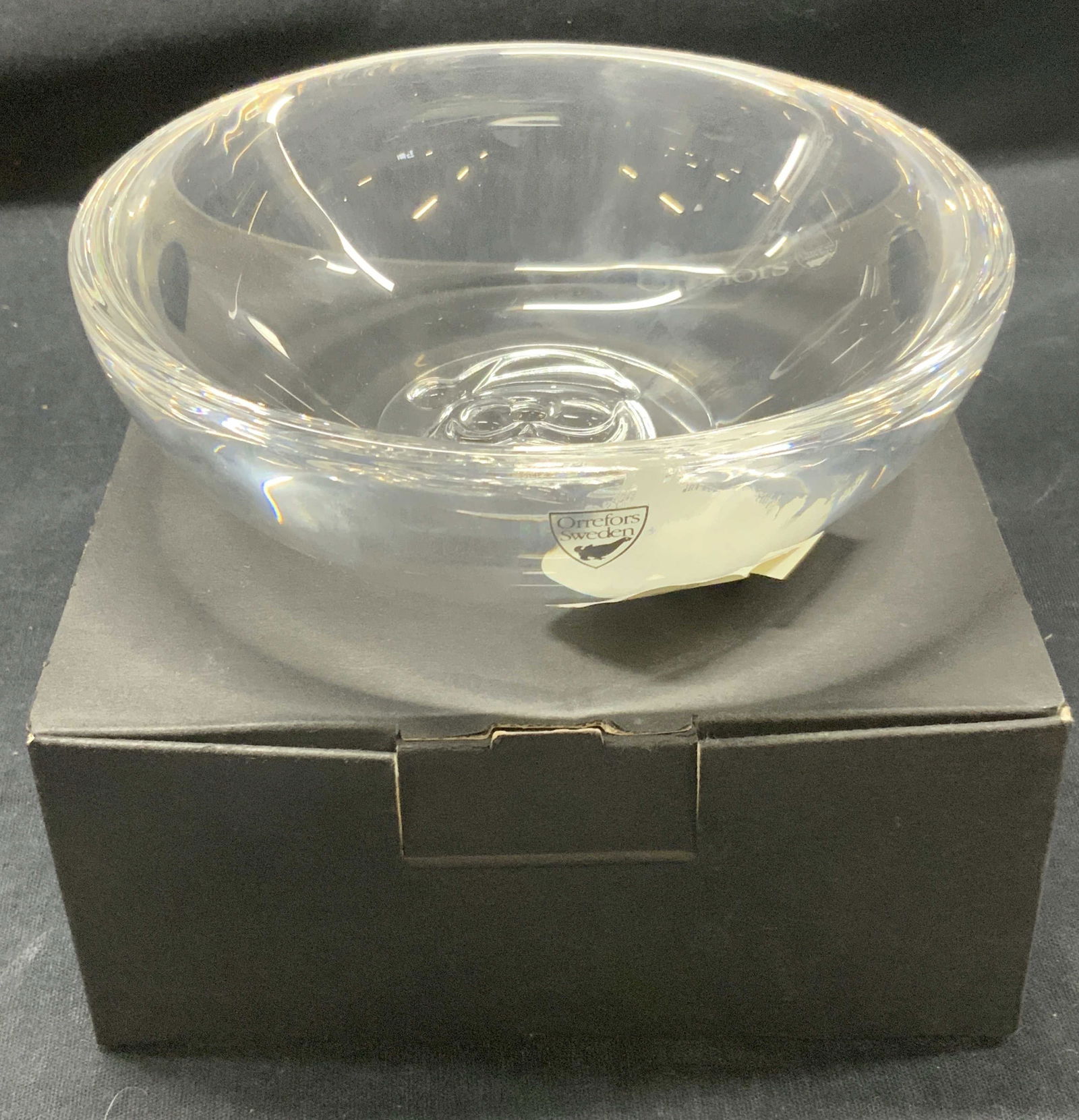 Orrefors Santa Holiday Crystal Bowl W Org Box: Orrefors crystal holiday bowl with an image of Santa on center. Marked on underside Orrefors. Comes in black original box marked Orrefors. Bowl appear never used, has original Nordstrom retail sticker