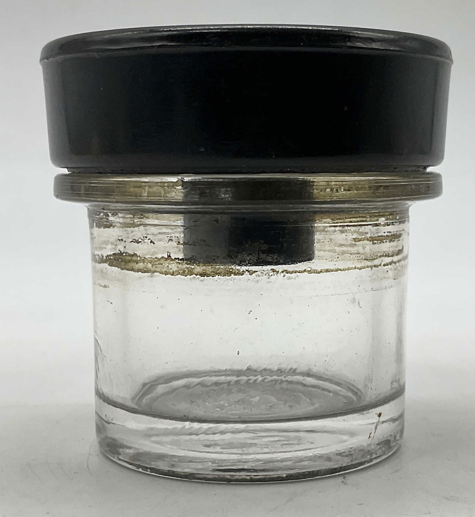 Antique Bakelite School Desk Inkwell: Antique Collectible Bakelite No. 59 School Desk Inkwell. Bottom of the glass pot embossed with "59". Measures approx. 2H x 2D in. Some surface wear consistent with age, and use. Some surface residue p