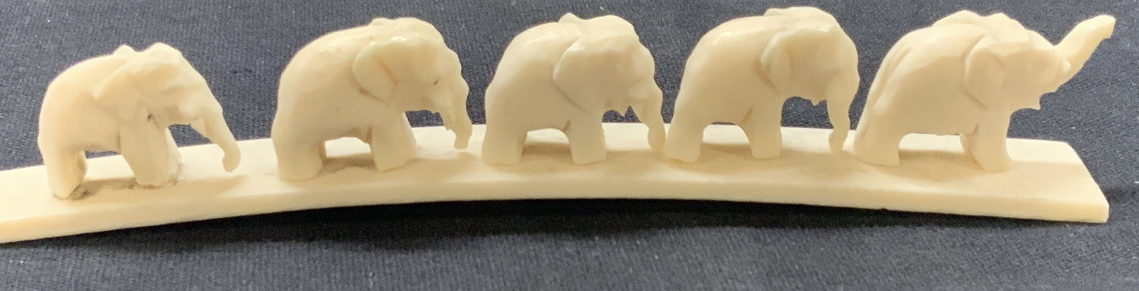 Carved Bone Elephant Herd Bridge: Carved bone elephant herd bridge with 5 elephants on a bone platform. Approx less than 1 inch tall and 5 inches long. Elephants need repair to attach onto platform, many are loose and come off. Carved