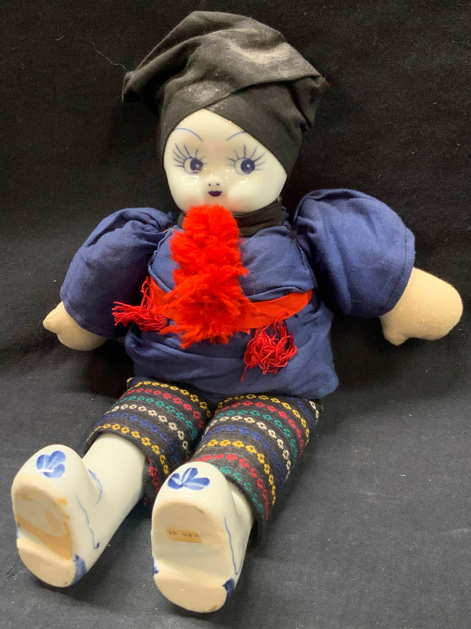 Vtg Porcelain Head & Feet Asian Fabric Doll: Vintage Asian doll with hand painted porcelain head and porcelain made feet with a fabric Body. Approx12 inches long and 11 inches wide. Moderate discoloration to fabric and to porcelain. Vintage porc