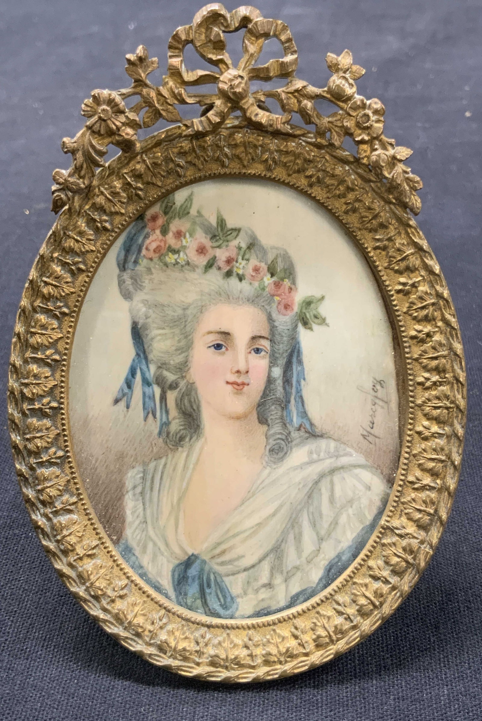Antique French Signed Portrait Painting On Bone: Antique French portrait painting on bone. Signed on lower corner possibly reads Marcqfoy Depicts a 18Th century woman in French fashion with tall hair with pink roses and blue ribbons in a white gown.