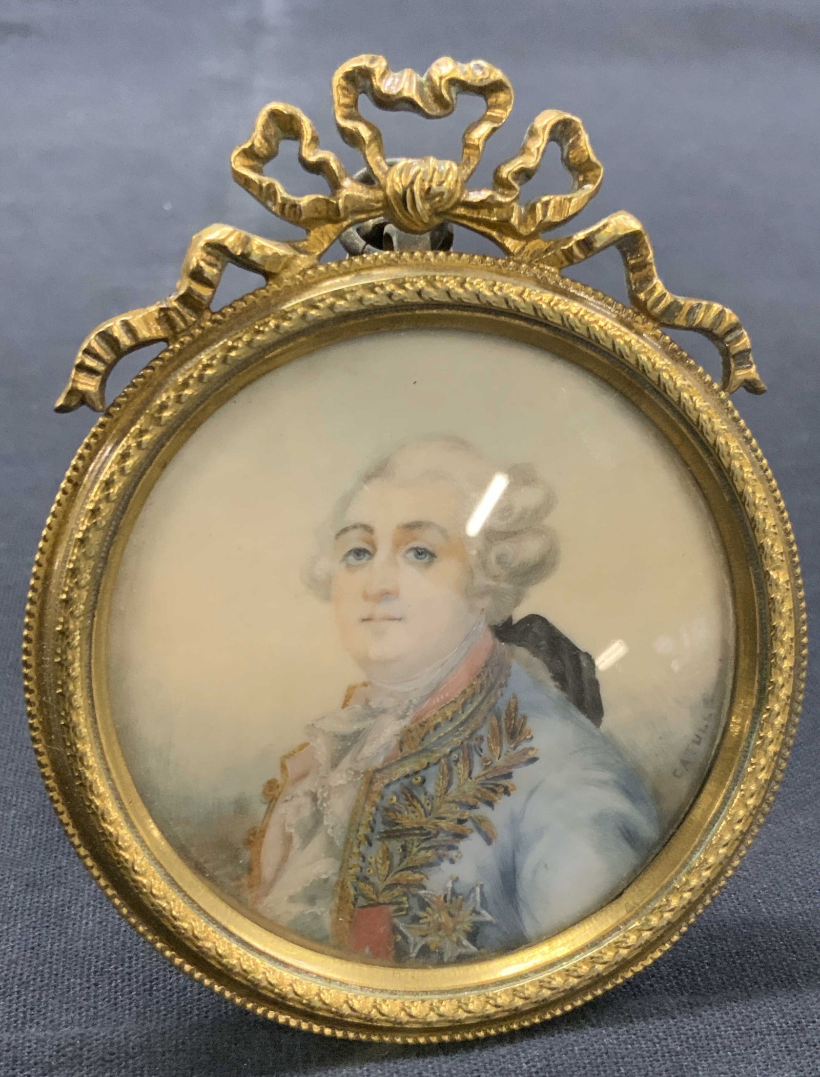 Signed Antique French Portrait Painting On Bone: Antique French portrait painting on bone. Signed on lower corner possibly reads Catulle. Depicts a 18Th century man in French fashion with powered wig and blue coat with gilt floral accents and ruffle