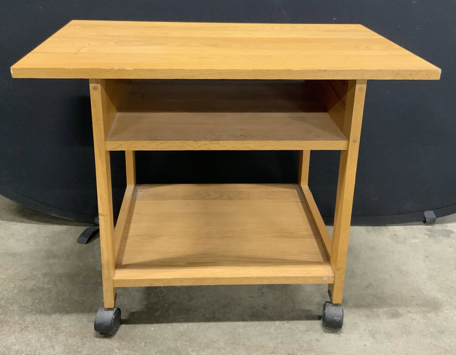 Vintage Wooden Kitchen Cart, Wheeled: A vintage wooden kitchen cart. Rectangular top with storage and shelf beneath. Four wheels. Measures approx. 23.25H x 20D x 30W in. Wear consistent with age, use, and exposure. Some discoloration and 
