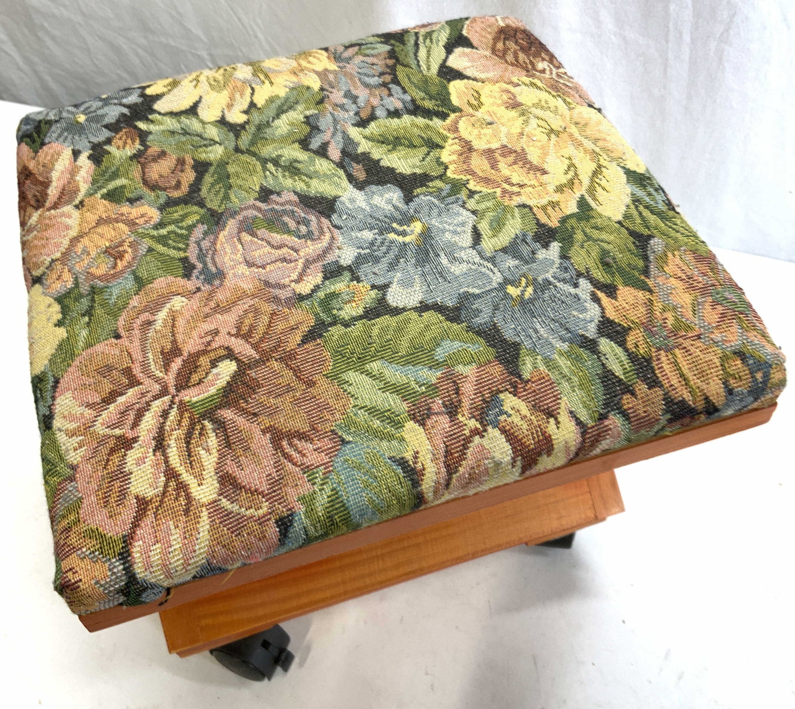 Etna Products Co Wooden Cushion Seat on Casters: Travel folding seat on casters with original label by Etna Products Co of New York. Foam pad with polyester floral fabric as seat. Needs 1 caster re- attached and is included. X stabilizer that fits i
