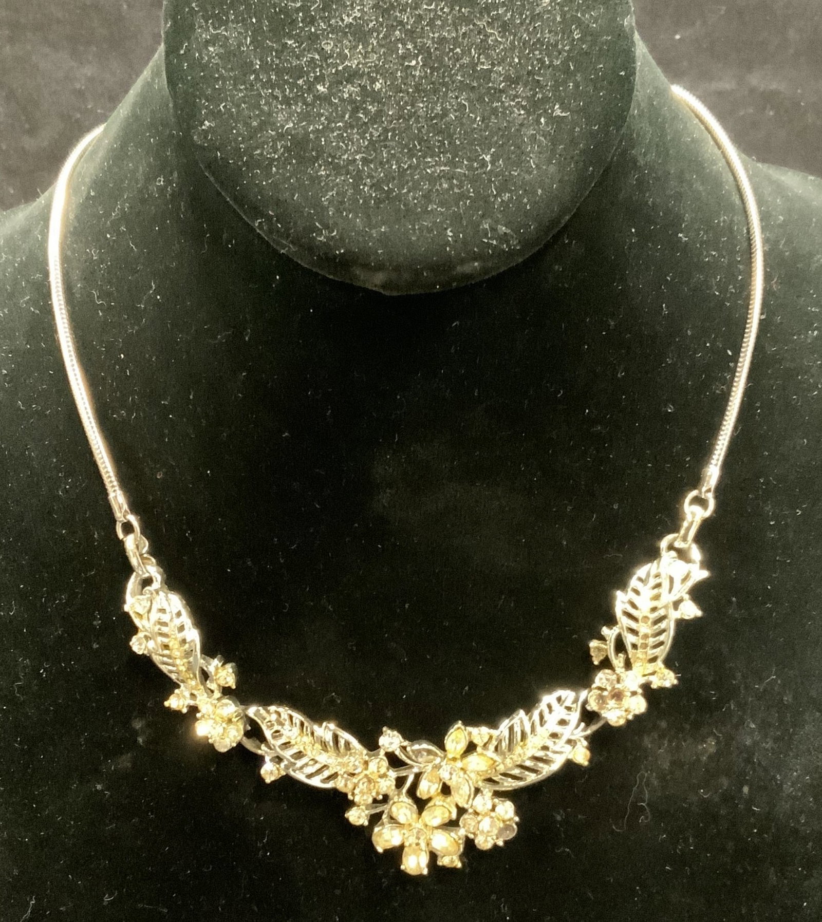 Vintage Silver Tone Crystal Flower Necklace: Vintage silver tone necklace with flower motif and crystal decoration. Drop length approx. 7 inches. Some surface wear including scratching observed. Some crystals needs replacement. Estate jewelry, c