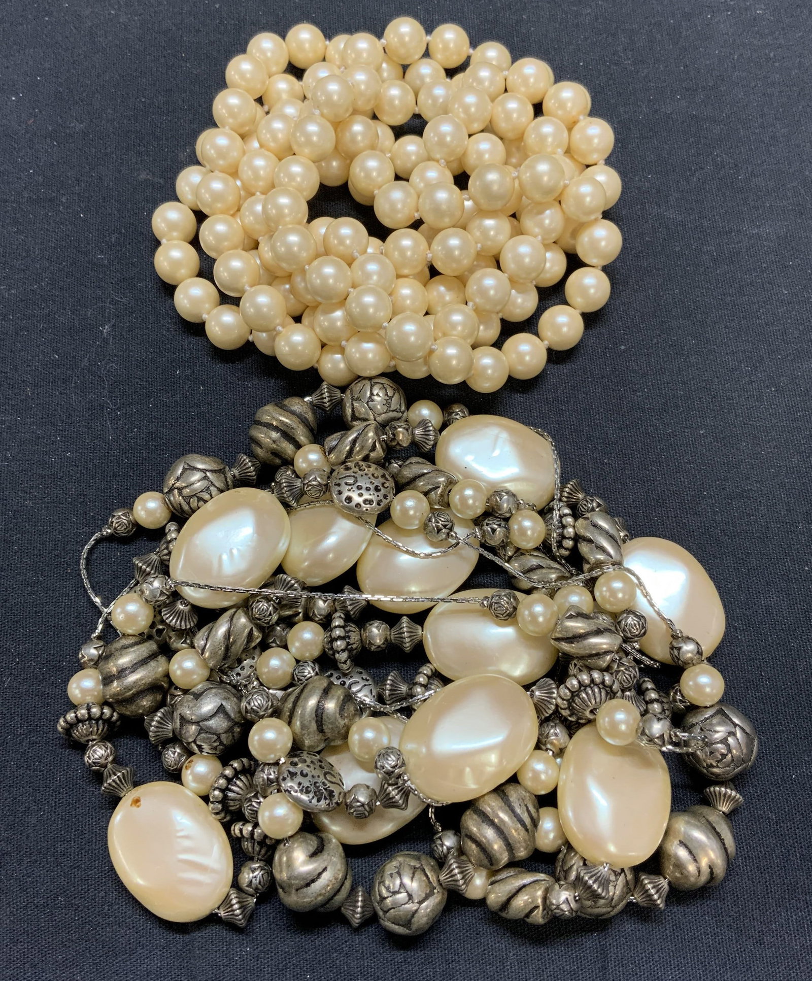 Lot 2 Dabby Reid Faux Pearl, Rope Necklace: Lot of 2 jewelry pieces. Dabby Reid faux pearl and silver tone beaded necklace. Signed on hang tag. Drop length approx. 45.5 inches. Faux pearl beaded rope necklace. Drop length approx. 26.5 inches. B