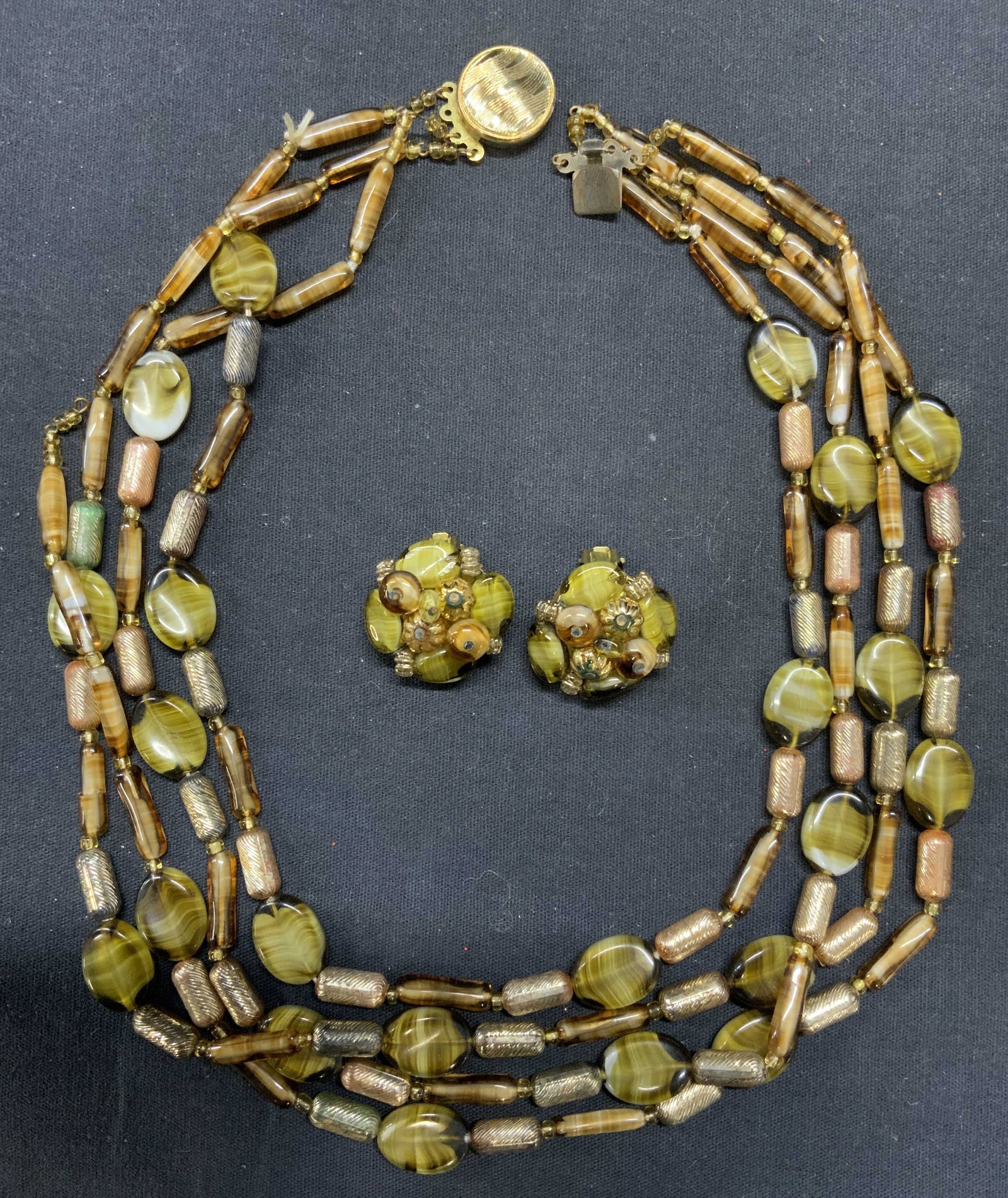 2 Green & Brown Beaded Necklace & Earrings Germany: Lot of 2 jewelry pieces. Vintage matching green and brown glass beaded necklace and clip on earrings set. Marked Germany. Necklace drop length approx. 8 inches. Earrings measures approx. 1 inch diamet