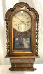 Antique Inlaid Victorian Wooden Wall Clock 33in: Wall clock appears to be antique possibly vintage. Piece is wooden with carved c scroll, side column & marquetry parquetry detail. Clock face is tan toned with black toned Roman numerals and hands. Cl