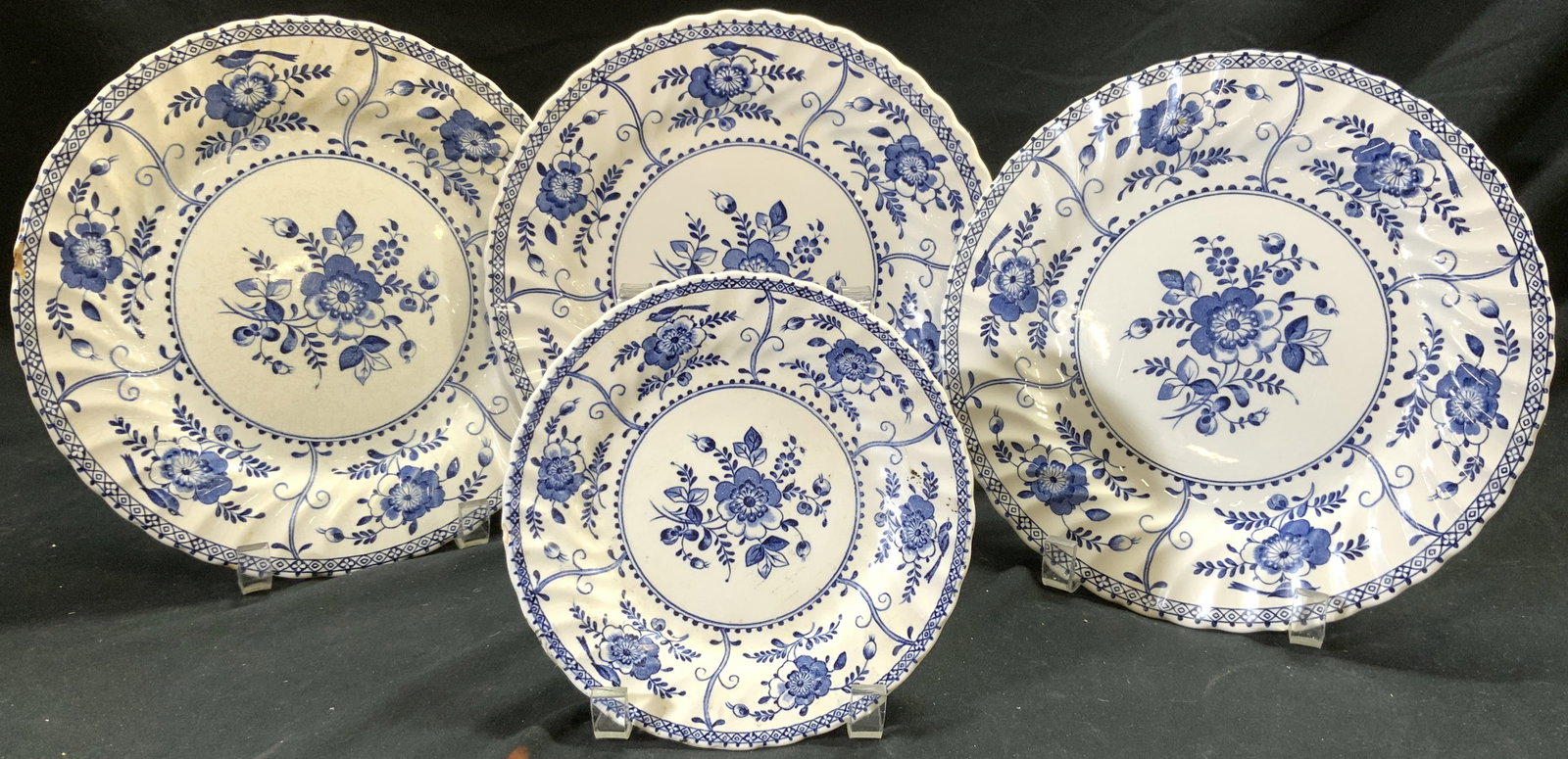 INDIES JOHNSON BROS Set 4 Vtg Porc Plates ENGLAND: Underside are marked INDIES MADE IN ENGLAND BY JOHNSON BROS. Lot includes 4 plates (3 large & 1 small). Each are white with blue toned floral & leaf detail with fluted rims. Largest plates measure app