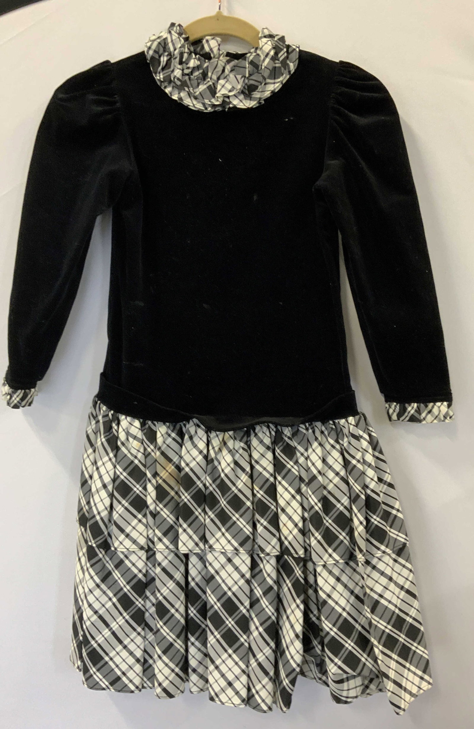 Elen Henderson/Bergdorf Goodman Girls Dress: Girls luxury black velvet dress with long sleeves , black and white plaid ruffle skirt, ruffle cuff trim, and ruffle collar. Labeled Elen Henderson and Boys & Girls BERGDORF GOODMAN on the Plaza. Has 