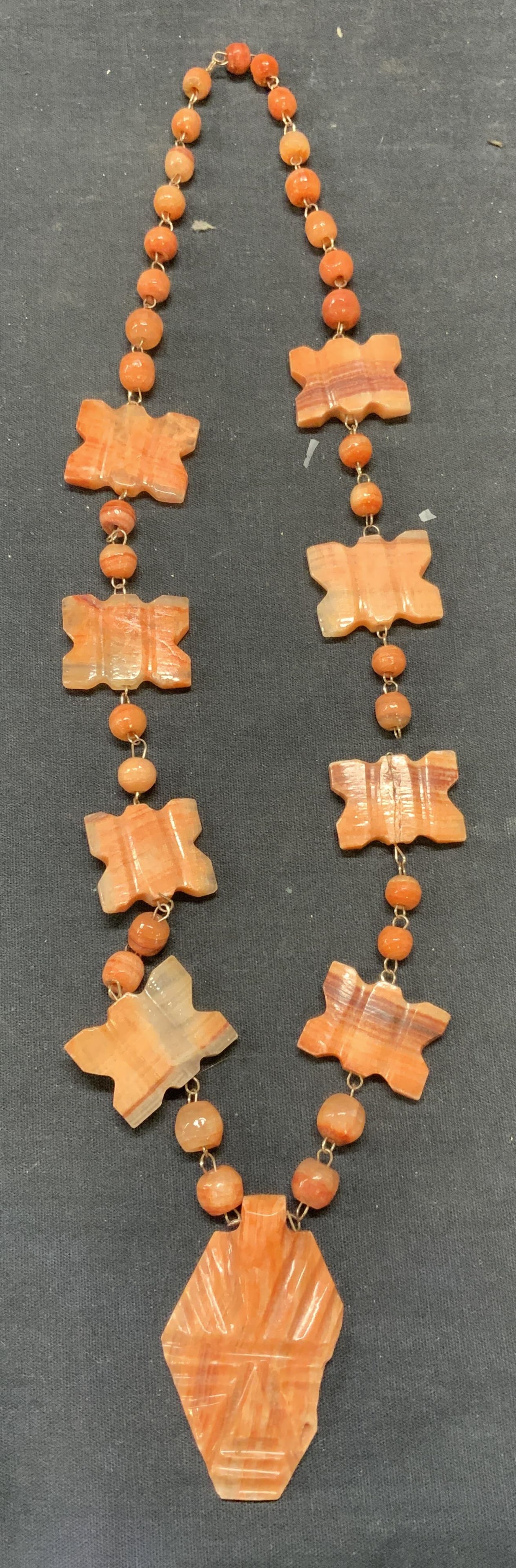 Vintage Pink Carved Stone Pendant Necklace: Vintage pink toned carved natural stone pendant necklace. Drop length approx. 12 inches. Some scratching observed. Chain needs repair. Estate jewelry, costume jewelry, fashion jewelry, cocktail jewelr