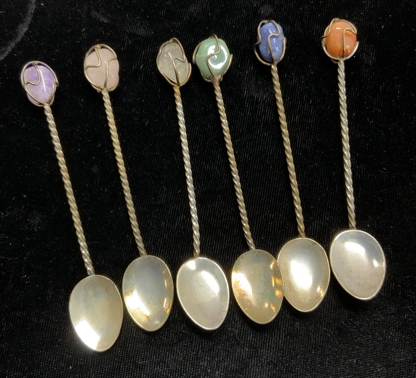 Set 18 Demitasse Spoons w Polished Gemstone, NIP: Hand crafted silver tone metal demitasse spoons with a polished gemstone nuggets tip. 2 packages totaling 12 spoons are sealed in original package. Gemstones measures approx 12 x 10 mm. Amethyst, clea