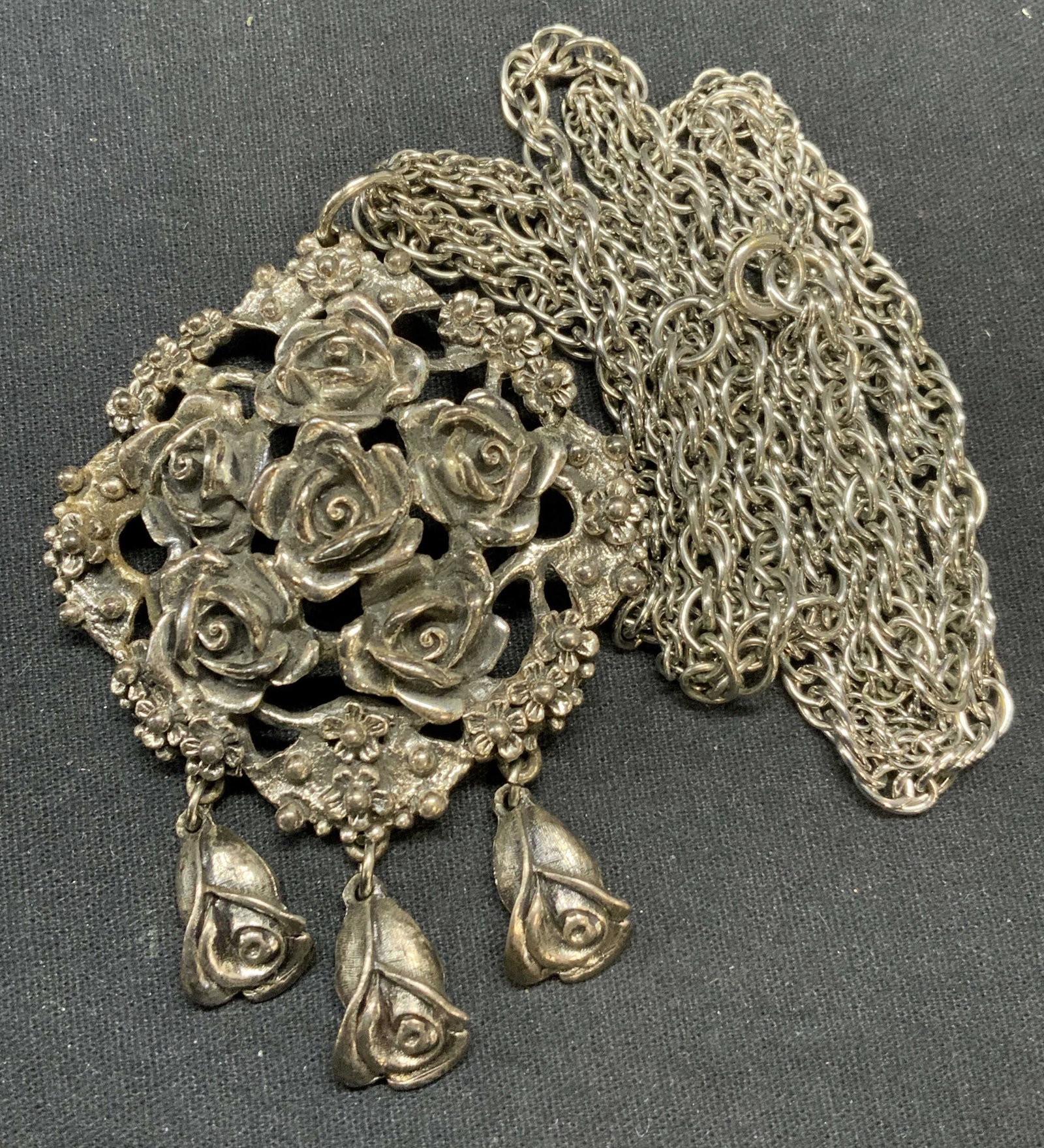 TORTOLANI Silver Tone Rose Pendant Necklace: Vintage TORTOLANI silver tone rose pendant necklace. Signed to underside of pendant. Drop length approx. 11.75 inches. Pendant measures approx. 3.25 x 2.25 inches. Some surface wear including scratchi