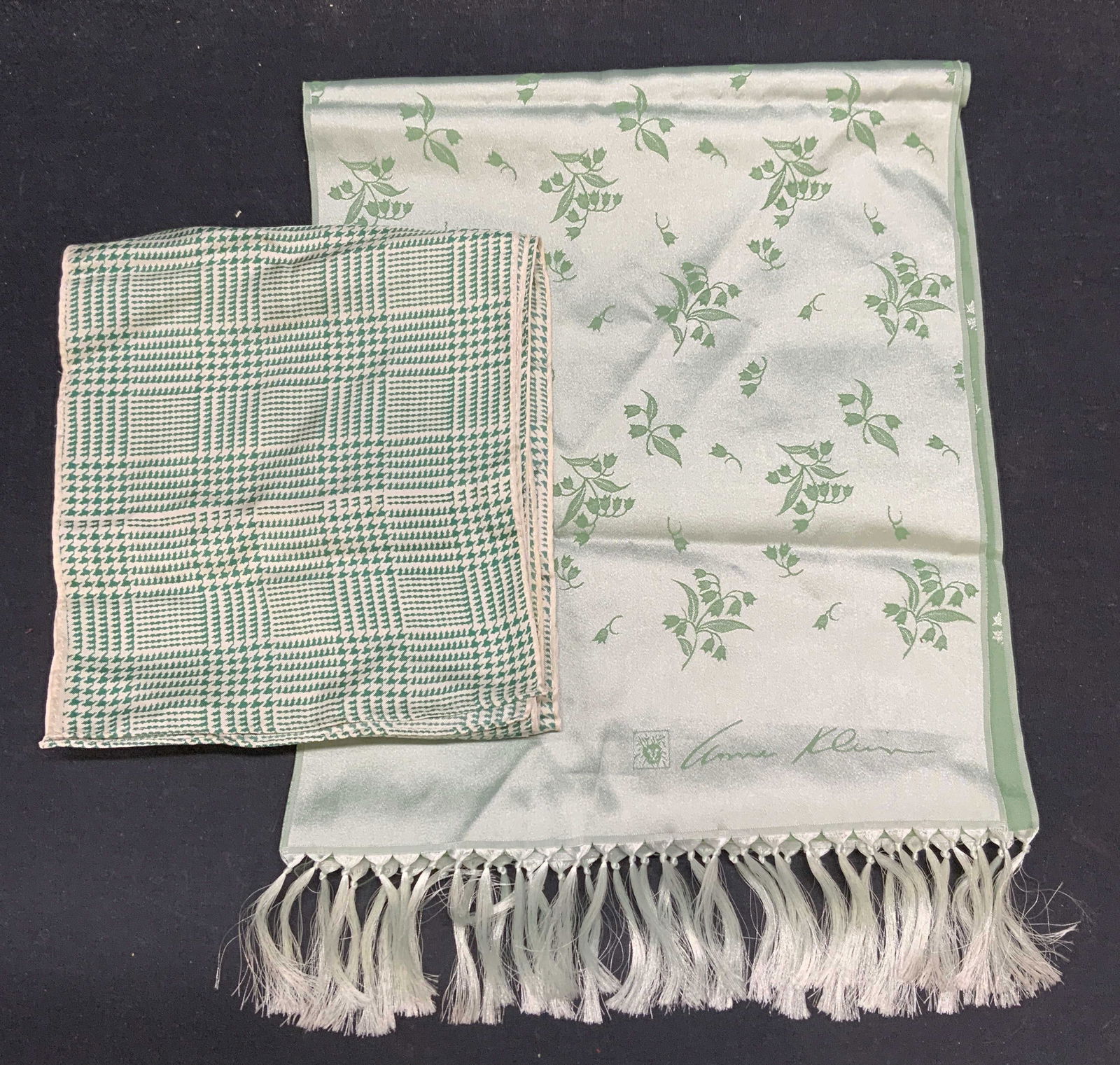 Lot 2 Anne Klein for Robinson Golluber Scarf, More: Lot of 2 scarves. Anne Klein for Robinson Golluber green floral scarf with tassel trim. Polyester. Designer label to lower corner and tag. Measures approx. 54 inches long. Green and white houndstooth