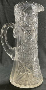 Brilliant Clear Cut Glass Water Pitcher: Brilliant antique clear Cut Glass Water Pitcher. Design includes pinwheel, crosscut diamond hob-star and an applied coin notched handle. Measures approx. 12H x 6.5 W in measured at widest point. Some