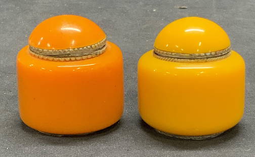 Lot 2 Vintage Orange Lucite Trinket Boxes: Lot of 2 vintage orange lucite, possibly Bakelite, and metal trinket boxes. Measure approx. 1 7/8 x 2 7/8 inches. Some surface wear to each consistent with exposure. Property from F.W. WOOLWORTH CEO B