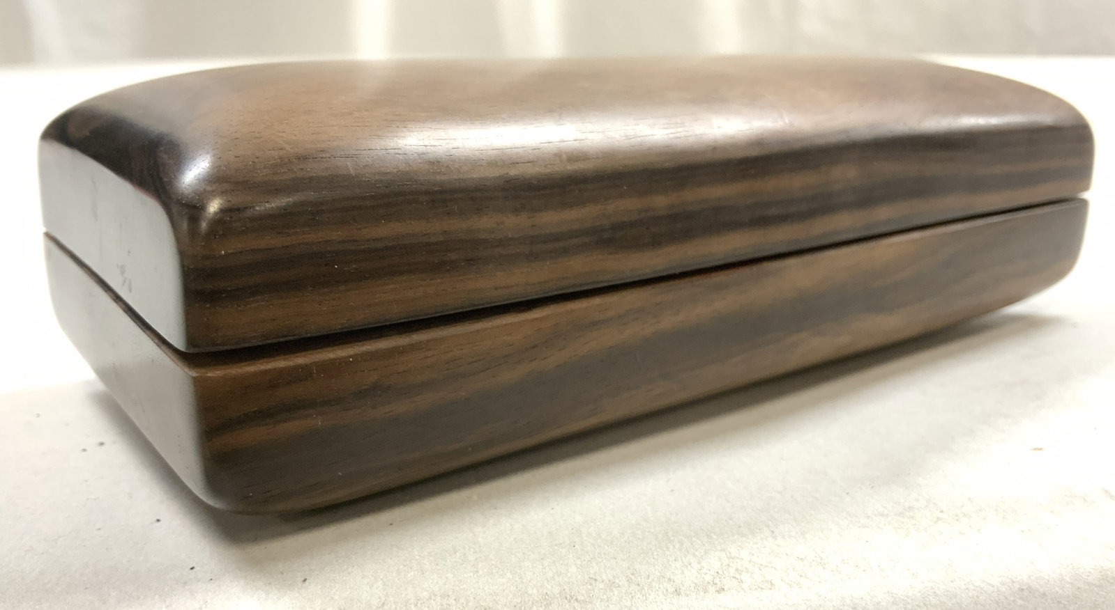 KOTUR NY HK Wood Texture Clutch W Inner Pocket: Interior has plaque which reads KOTUR NEW YORK HONG KONG. Exterior has brown toned wood texture. Interior is copper toned & has ornately embroidered detail. Interior has pocket area. Piece has gold to