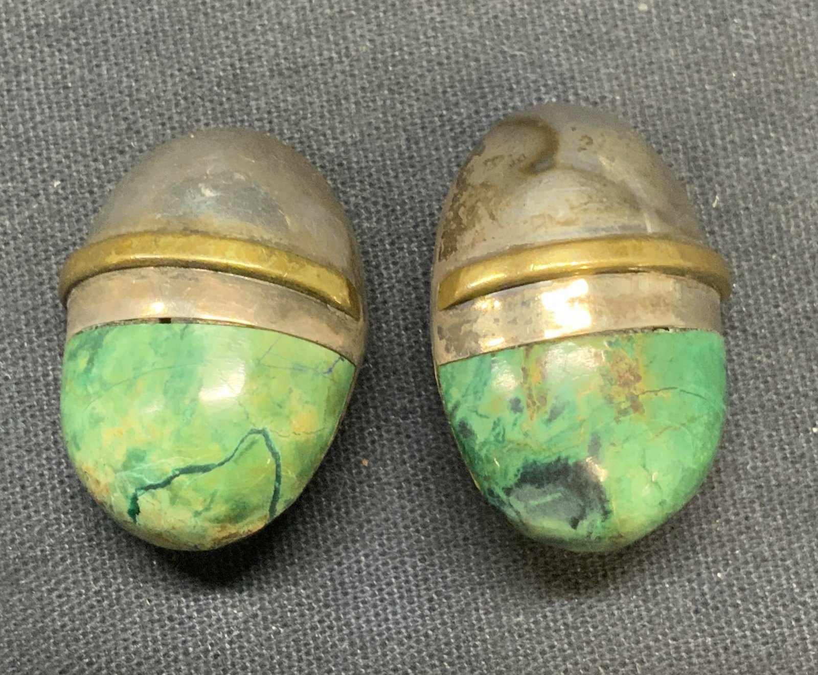 Vintage Sterling Silver & Stone Earrings, Mexico: Vintage sterling silver earrings with green natural stone. Clip on. Marked Mexico, 925. Measure approx. 1 1/8 x .75 inches. Total weight 22.2 grams. Some surface wear in slug in scratching observed. E