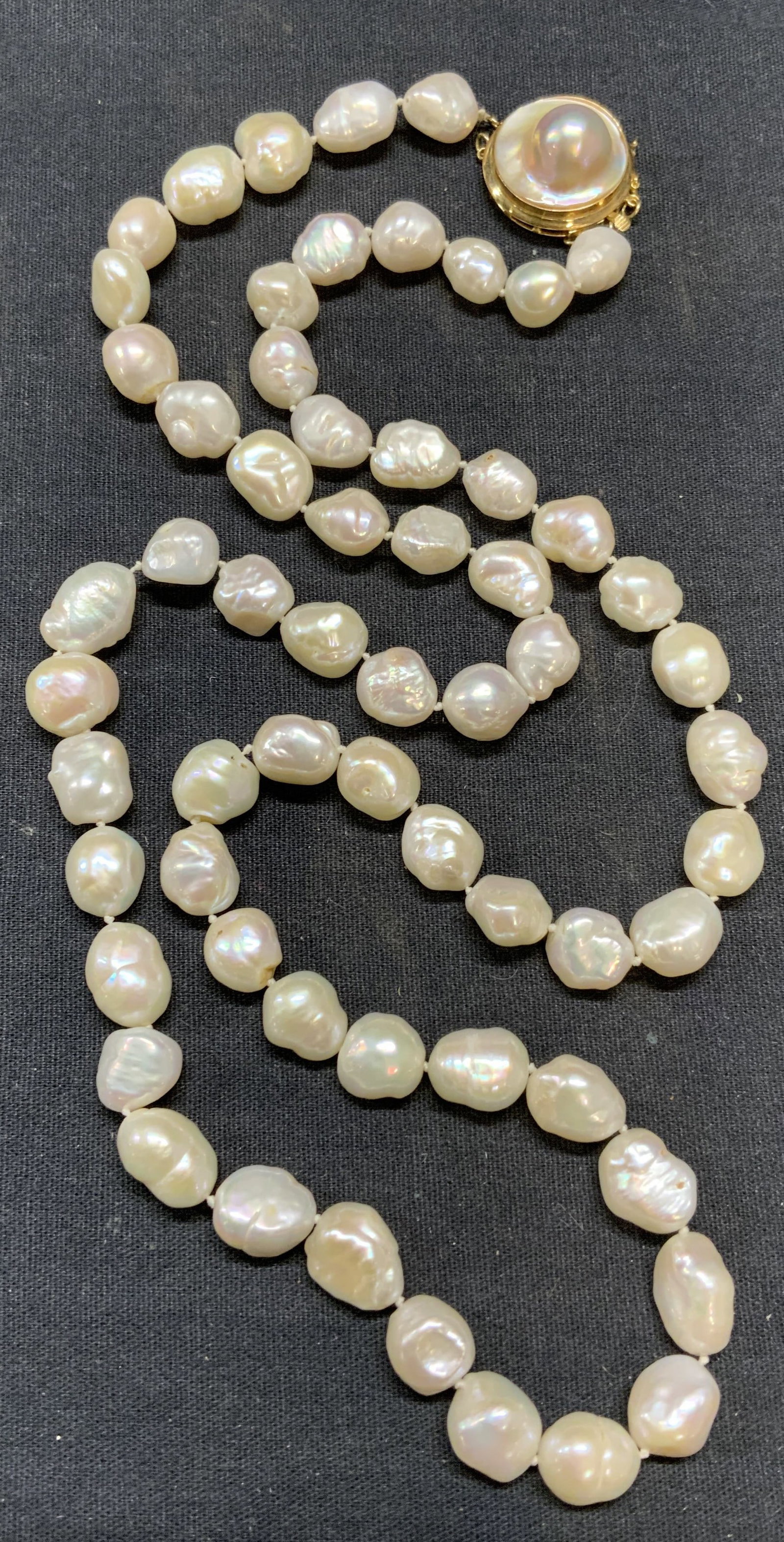 White Baroque Pearl Beaded Necklace: White baroque Pearl beaded necklace in double knotted string. Blister pearl clasp. Drop length approx. 14.5 inches. Total weight 459 carats. Some surface wear including scratching observed. Estate jew