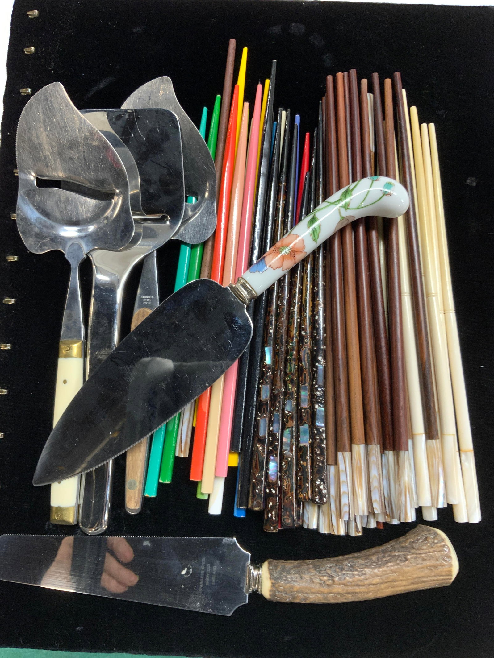 Lot Kitchen Acc Chopsticks, Cheese Slicers, Knives: Large lot of chopsticks with mother of pearl tops or inlaid mother of pearl. Set of colored lacquered wood, dark wood, and bone style. 9.5 in. Long. 3 hand held cheese slicers, stainless steel blades.