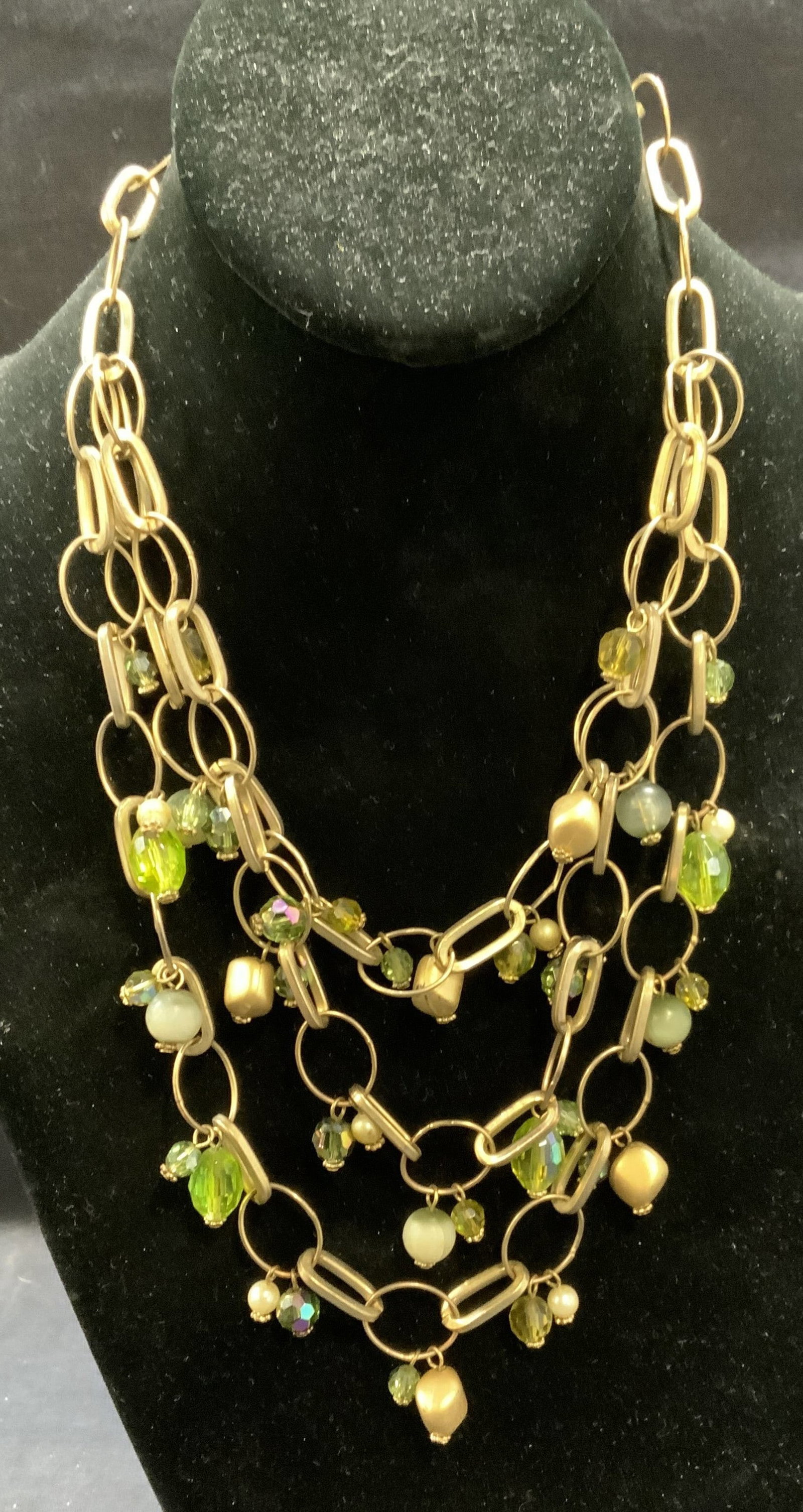 Gold Tone Green Crystal Necklace: Gold tone multi strand necklace with green crystal decoration. Drop length approx. 8.5 inches. Some surface wear including scratching observed. Estate jewelry, costume jewelry, cocktail, jewelry, fash
