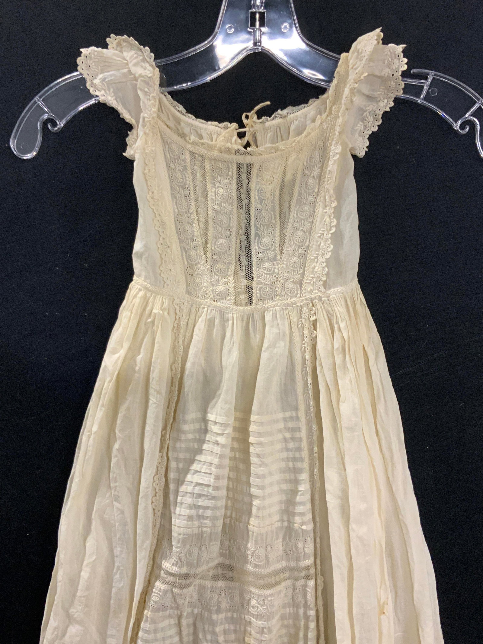 Vintage Handmade Cotton Christening Gown: handmade baby christening gown. Made of cotton fabric with floral detail and dainty sleeves. Floral eyelet trim. 2 ties in the back. 43 in. Long. Antique white cotton., gown flares wide at 64 in. circ