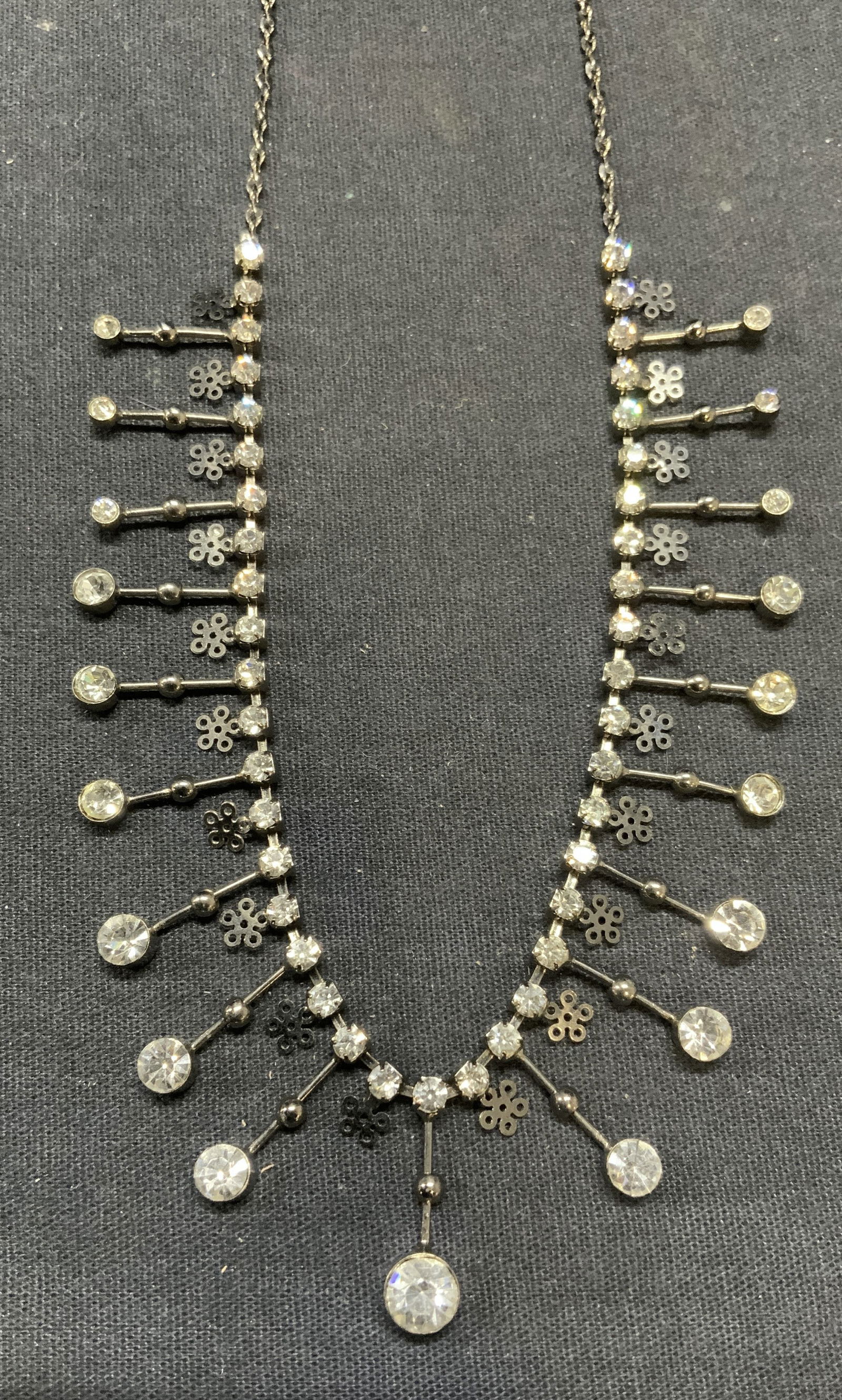 Vintage Silver Tone Crystal Necklace: Vintage silver tone necklace with crystal and flower decoration. Drop length approx. 9 inches. Some surface wear including scratching observed. Estate jewelry, costume jewelry, cocktail jewelry, fashi