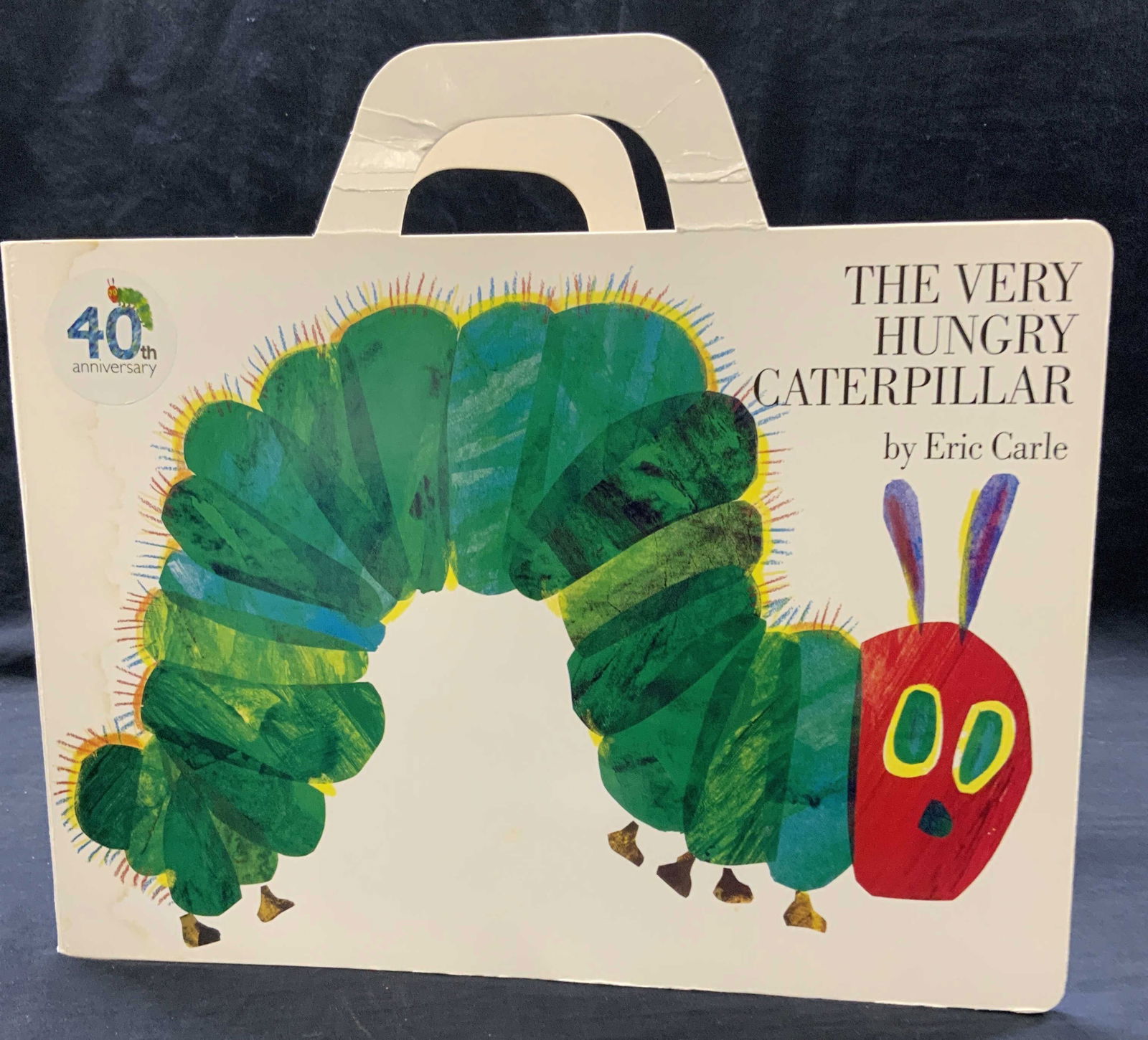 The Very Hungry Caterpillar 40th Anniv, Eric Carle: Oversized board book, 40th Anniversary edition of The Very Hungry Caterpillar by Eric Carle. Has handles, measures 15.75 in. Long x approx 14 in. Ht. Philomel Books, c. 1987. Some watermarks on cover