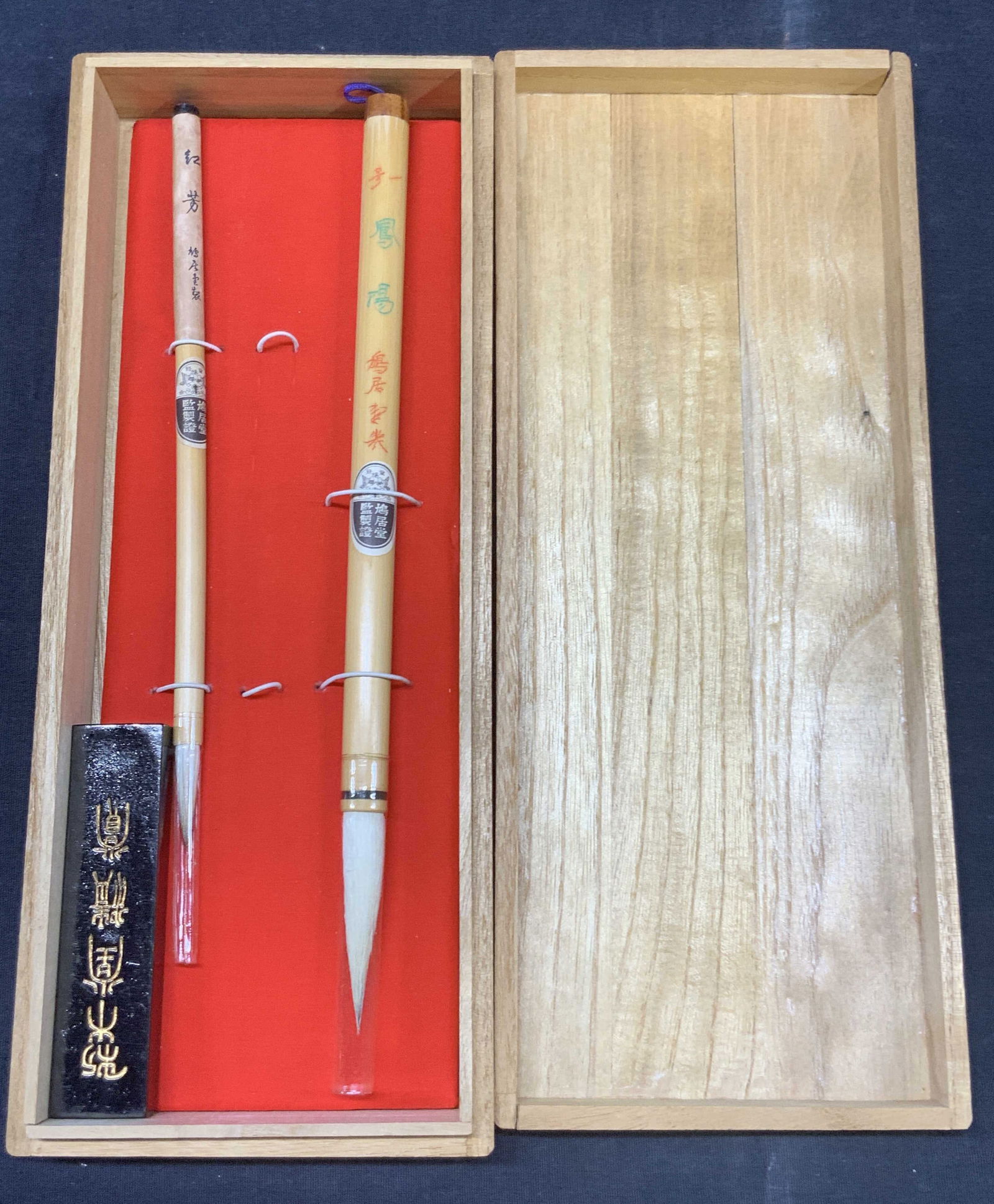 2 Asian Calligraphy Bamboo Brushes NIP: Set of 2 calligraphy brushes with handles made bamboo, and comes with a black ink block. New in box, marked with Chinese on lid, brushes range in sizes, 10 and 8.5 inches long. Box has moderate wearin