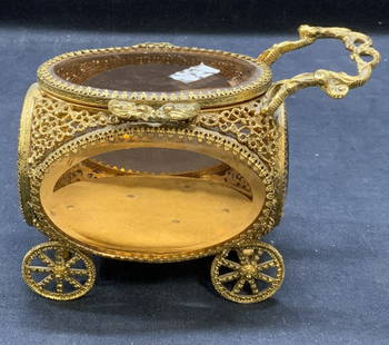 Vintage Gilt Ormolu Carriage Jewelry Box: Vintage, possibly antique, gilt ormolu carriage from jewelry box. Pieces scroll motif frame with beveled glass. Hinged lid opening. Measures approx. 6 x 3.75 x 4.25 inches. Piece has weight. Surface w