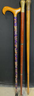 3 Vtg Wood /Lacquered Paisley Walking Sticks/Cane: Solid Wood Vintage walking sticks with brass handle, marked 21. Dark wood walking stick unscrews into 3 parks. It has a rubber foot, 35 in. Long. Oak wood walking stick has a painted tip, measures 34.