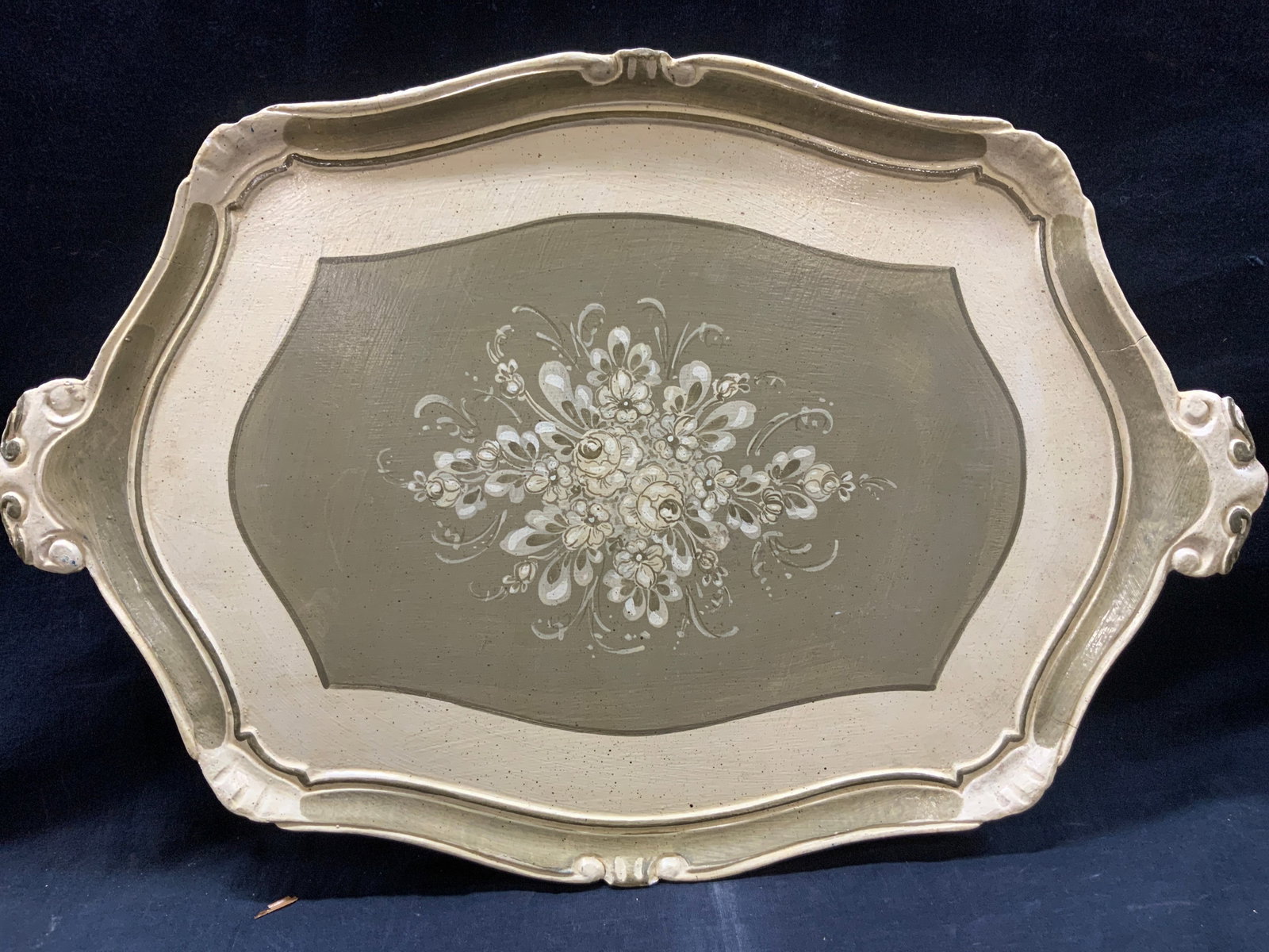 Vintage Hand Painted Wooden Tray, Italy: Marked made in Italy. Hand painted wooden tray with floral bouquet in the center with tones of off white and green. Approx 23 inches long and 14.5 inches wide. Moderate wearing to tray and cracking to