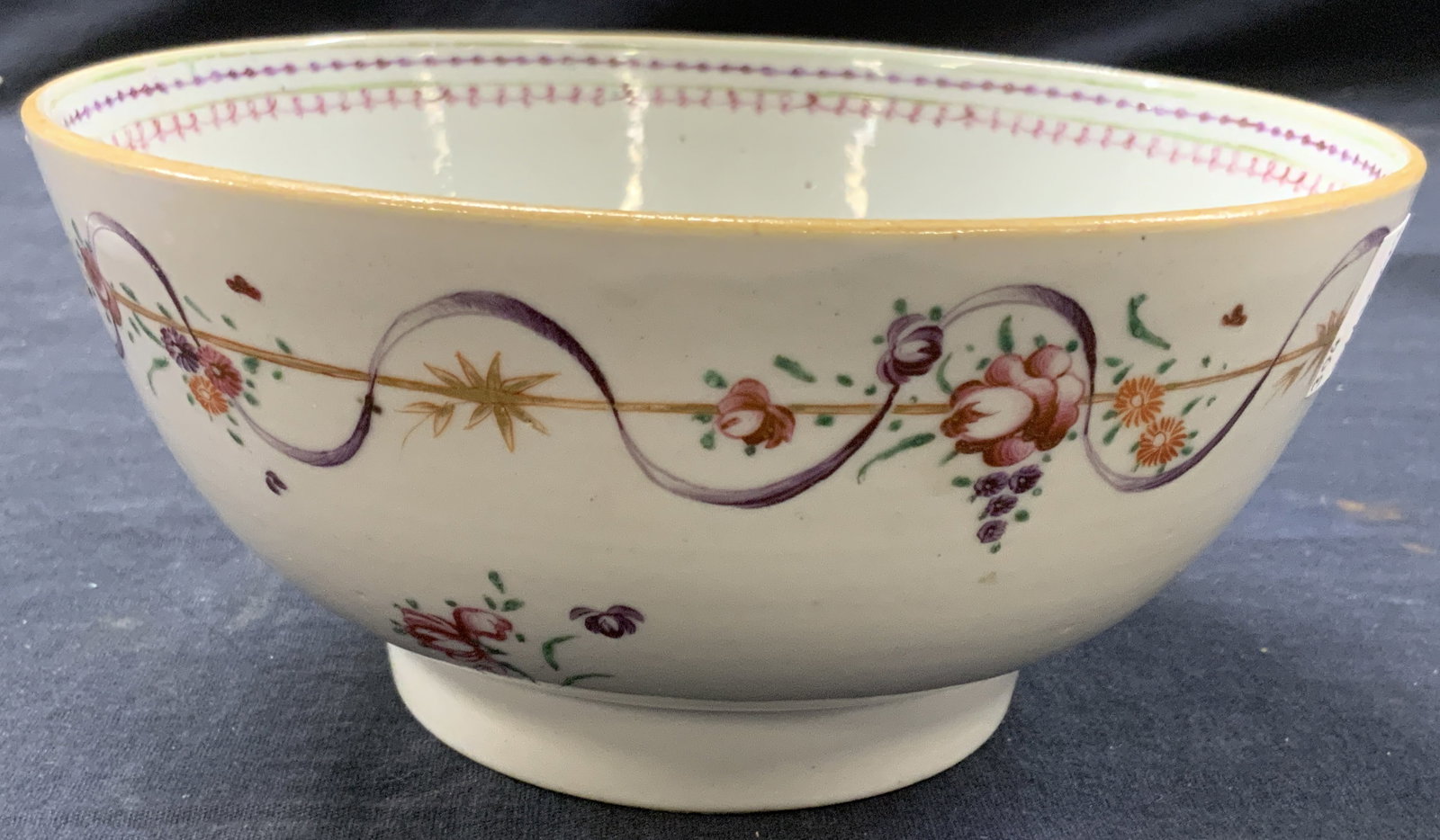Vintage Hand Painted Ceramic Bowl: Vintage ceramic bowl, hand painted on exterior with floral motifs, and interior edges with ribbon motifs in purple and pink with green. Approx 3 inches tall and 6.75 inch diameter. Moderate surface we