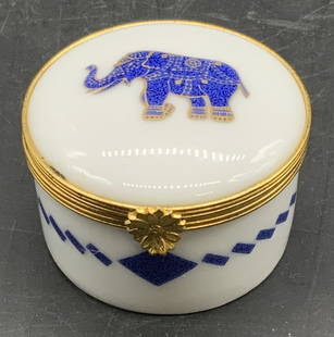 LIMOGES FRANCE CRILLON Porcelain Pill Box: A vintage elephant motif porcelain trinket / pill box. Gilt and blue hues throughout. Lid opens with metal hinge hardware. Underside signed CRILLON, PLACE DE LA CONCORDE, PORCELAINE LIMOGES FRANCE, SP