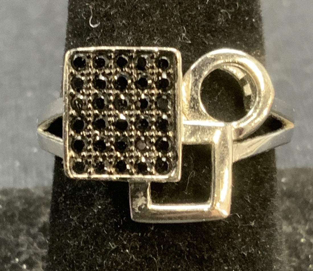 Vintage Sterling Silver Black Gemstone Ring: Vintage sterling silver ring with pave black gemstones and geometric setting. marked 925. Ring size 8. Total weight 4.3 grams. Some surface wear including scratching observed. Estate jewelry, fine jew