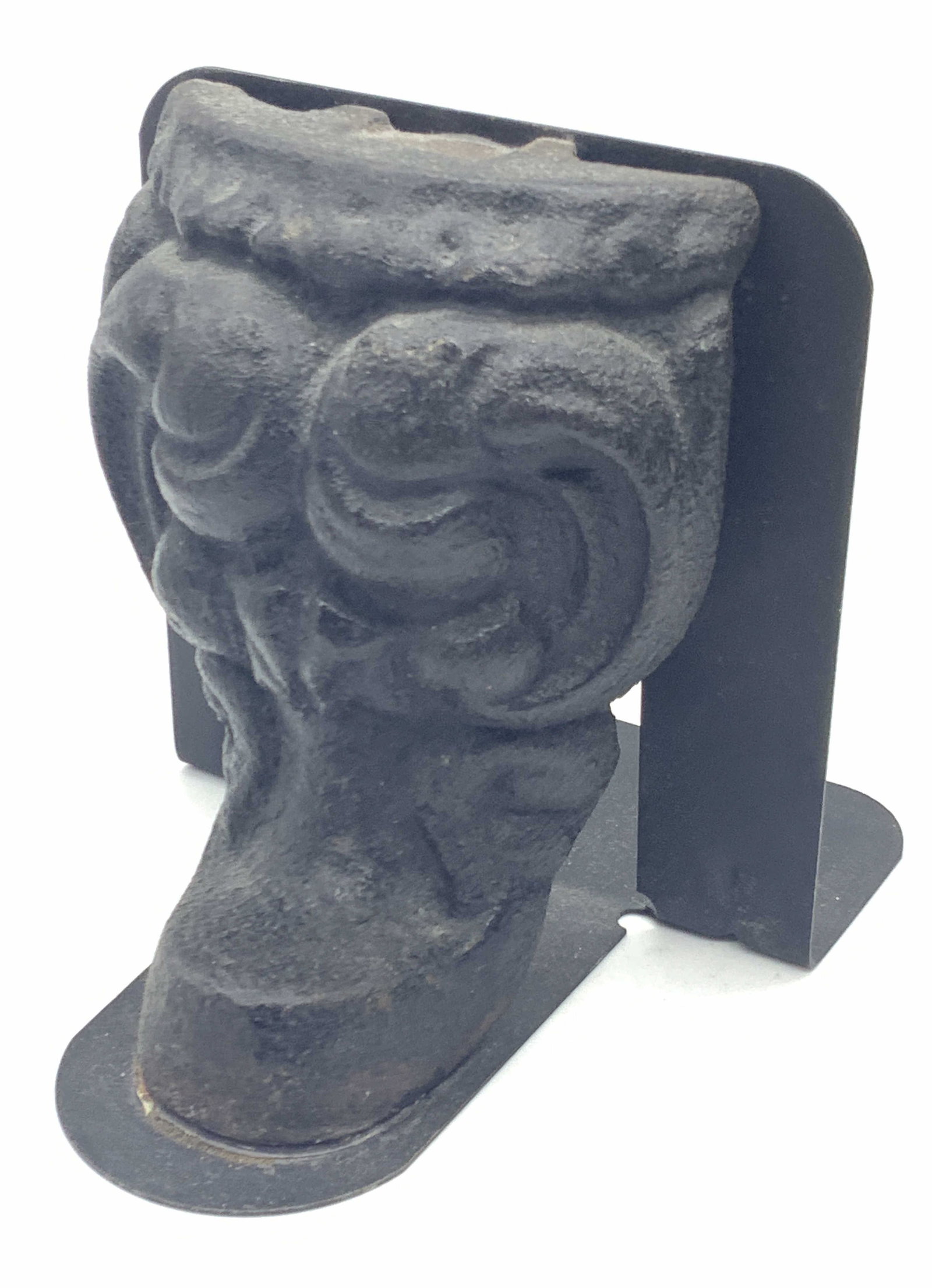 Vintage Cast Iron Book End: Vintage cast iron bookend with black metal backing. Iron looks like the bottom footing an objected. Approx 5 inches tall and 6 inches long and 5 inches wide. Moderate oxidation to iron and wearing to 