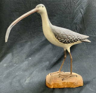 Vintage Wooden Curlew Bird Figural: Sculpture depicts a curlew standing on a rock. Bird sculpture is wooden. Piece has relief detail to mimic texture of feathers. Figure measures approximately 9.75 inches tall 10.5 inches deep 5.75 inch