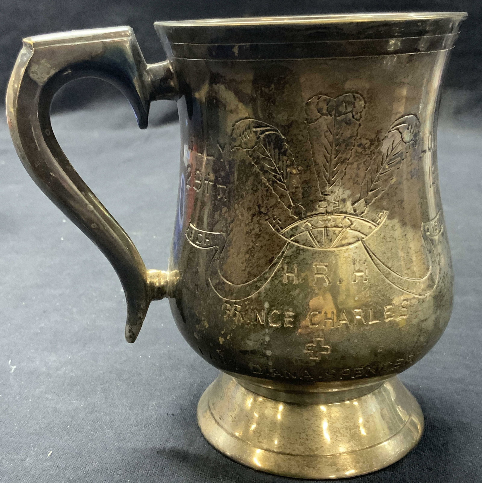 Vntg Silverplate Charles & Diana Marriage Mug 1981: Vintage silver plate mug, etched H.R.H. Prince Charles + Lady Diana Spencer, July 29th, London, 1981. Approx 5 inches tall and 3.5 inch diameter. Evident discoloration to silver plating throughout and
